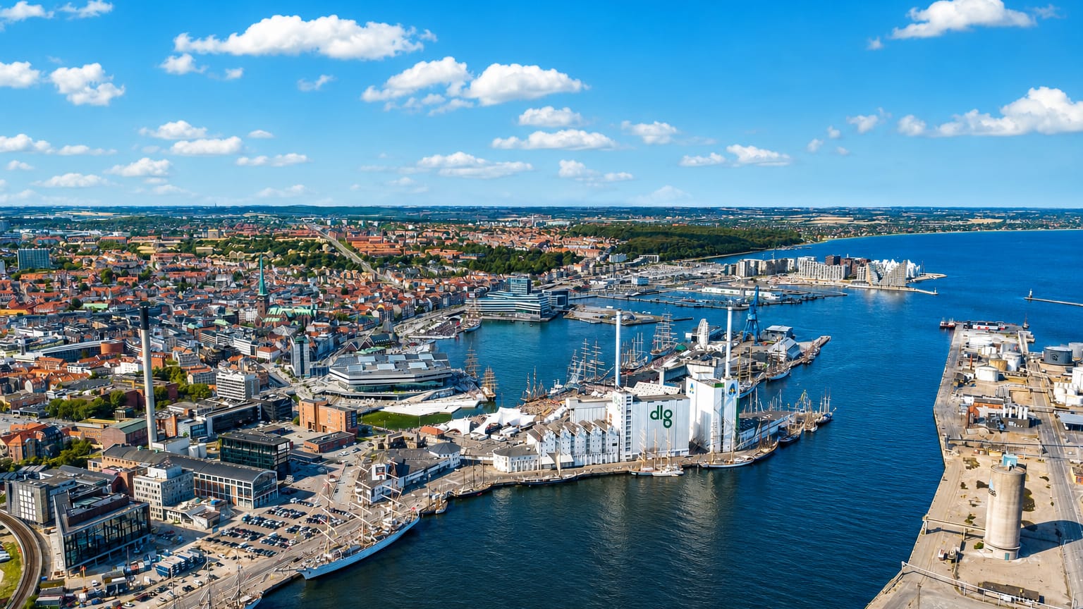 Aerial of Aarhus harbour and docklands with the DLG tower, old-town rooftops and cathedral spire