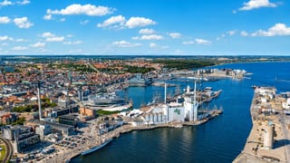 Aerial of Aarhus harbour and docklands with the DLG tower, old-town rooftops and cathedral spire