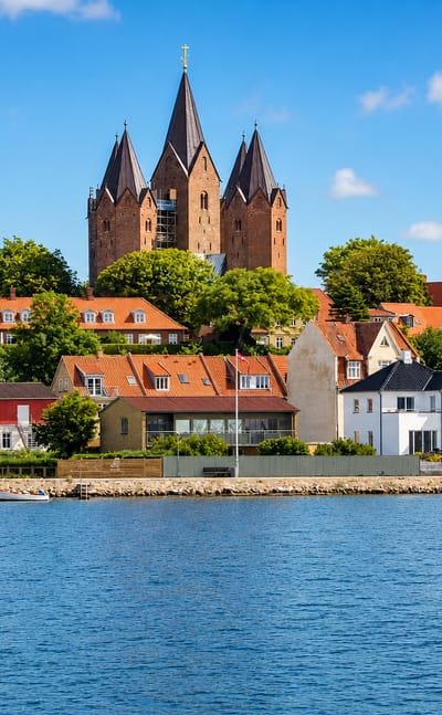 Waterfront of Kalundborg, Denmark below the five-towered Church of Our Lady rising over red roofs