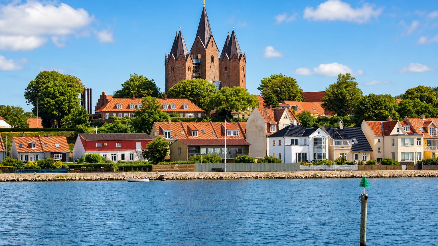 Waterfront of Kalundborg, Denmark below the five-towered Church of Our Lady rising over red roofs