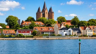 Waterfront of Kalundborg, Denmark below the five-towered Church of Our Lady rising over red roofs