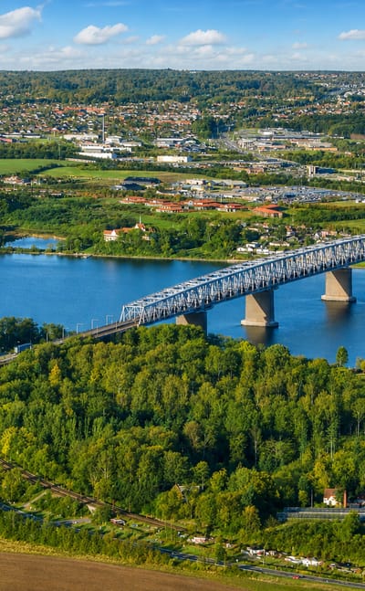 Aerial view of the Little Belt bridge crossing to Middelfart, Denmark over blue water
