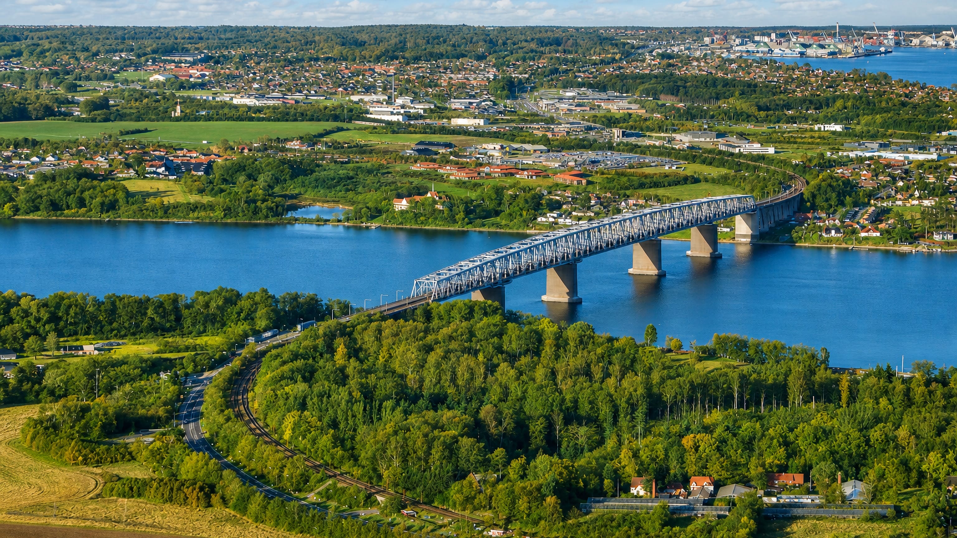 Aerial view of the Little Belt bridge crossing to Middelfart, Denmark over blue water