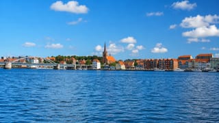 Sonderborg's waterfront with the Christian X pontoon bridge, church spire and old warehouses, Denmark