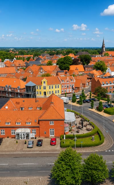 Aerial view of Tønder, Denmark with red-tiled roofs, brick buildings and a distant church spire