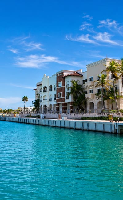 Turquoise marina lined with Mediterranean-style resort buildings and palms in Punta Cana, Dominican Republic