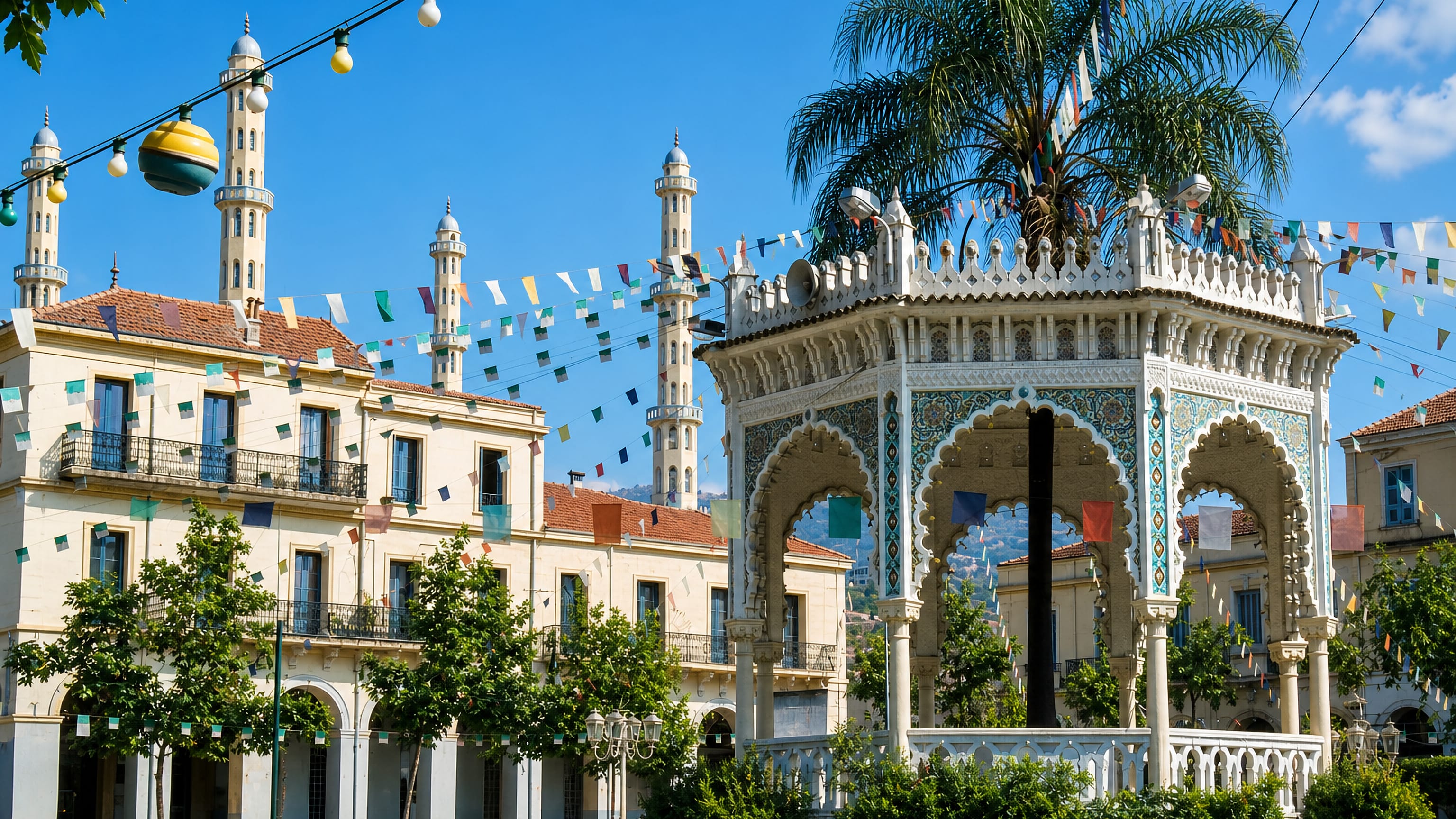 Ornate Moorish bandstand and French-colonial arcades on a palm-shaded square in Blida, Algeria.