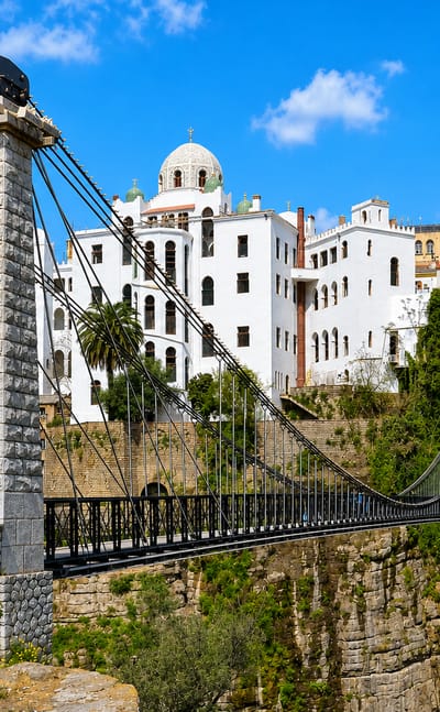 Constantine's Sidi M'Cid suspension bridge spanning the Rummel gorge below white hillside buildings