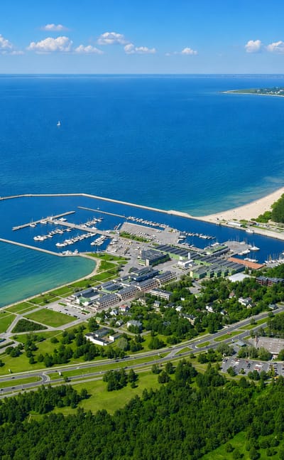 Aerial view of Pirita's yacht marina, sandy beach and pine-lined coastline on Tallinn Bay