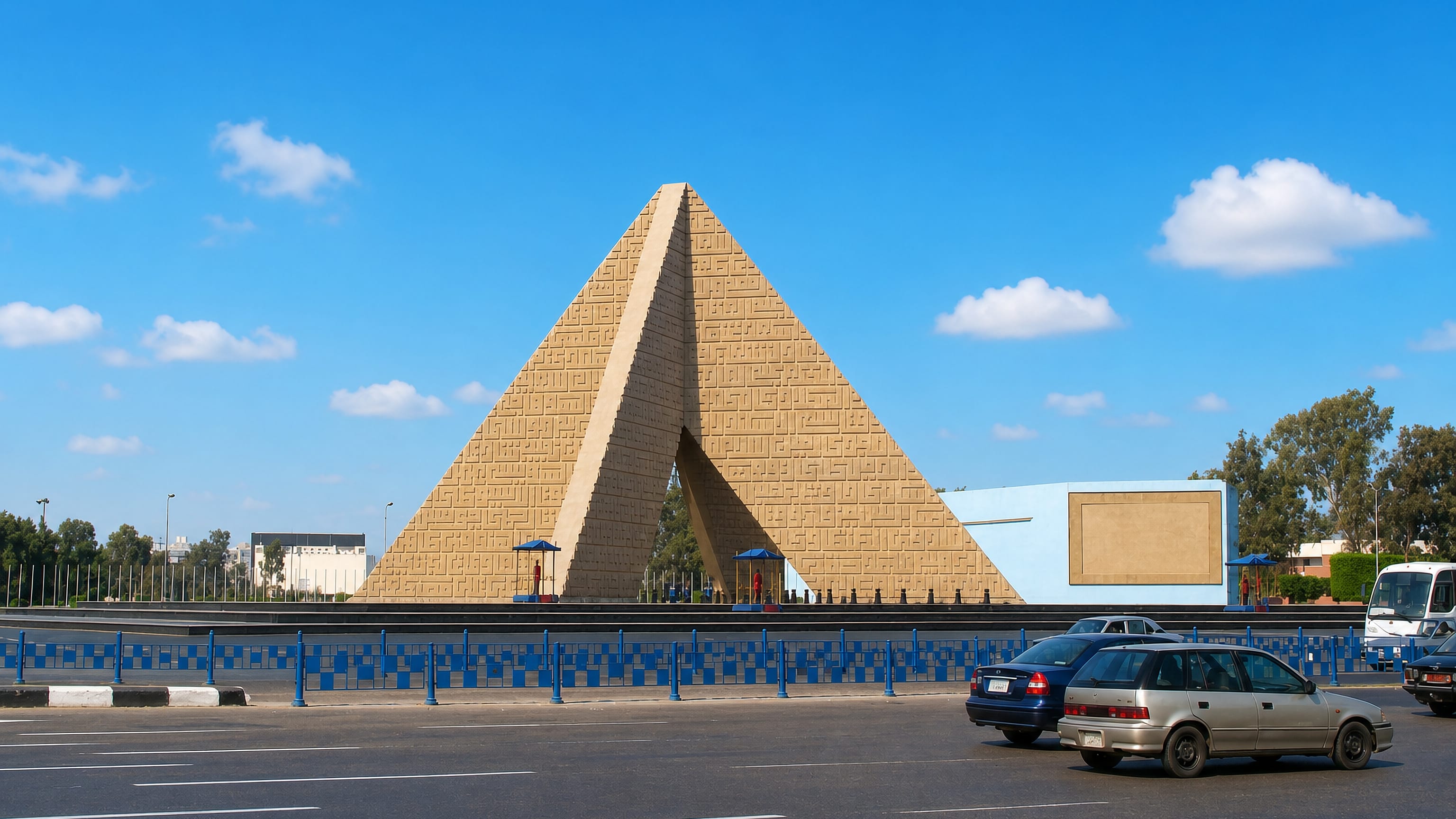 The pyramid-shaped Unknown Soldier Memorial beside a wide road in Nasr City, Cairo.