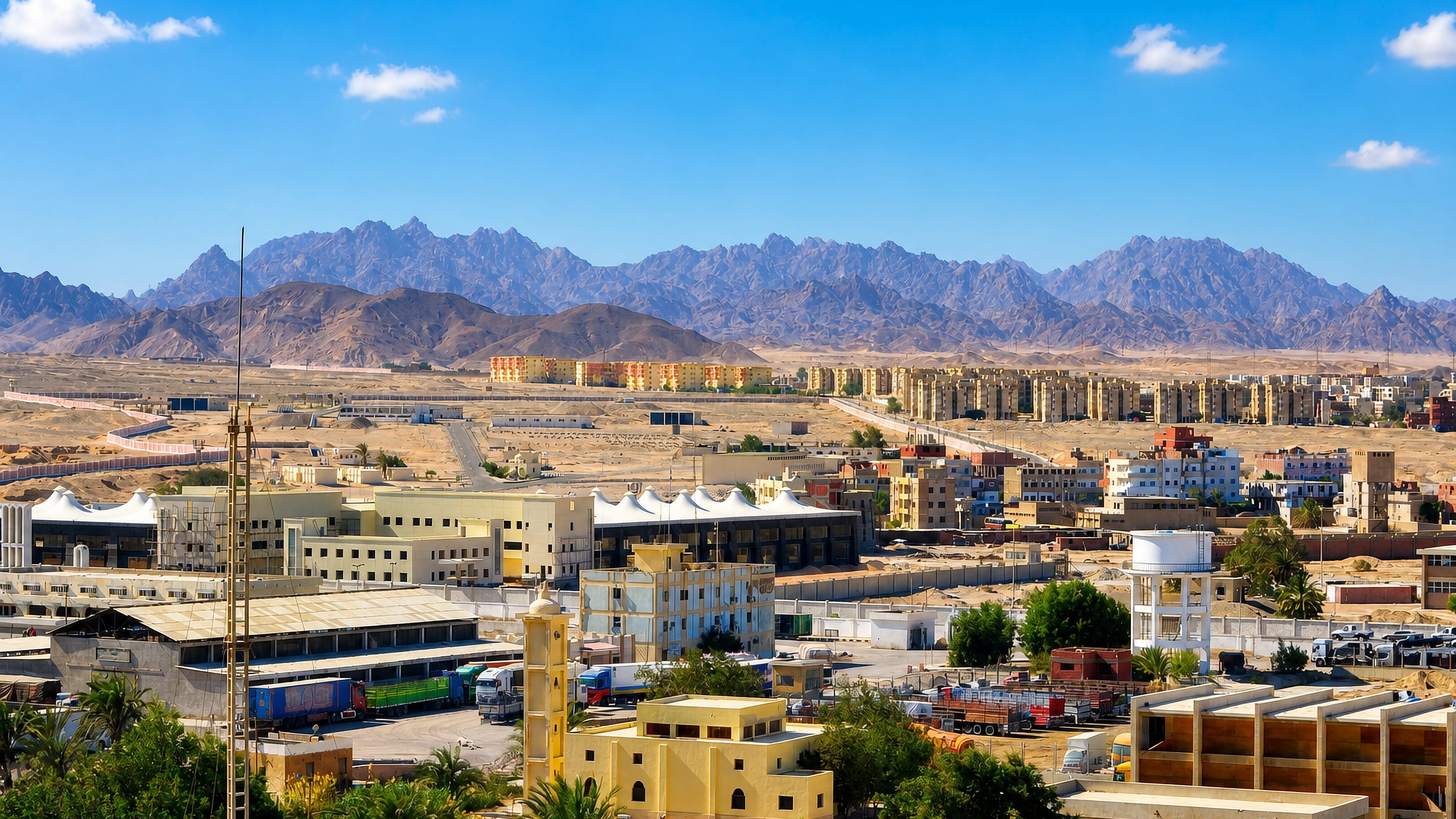 Safaga's low-rise desert townscape in Egypt, with the Red Sea Mountains rising behind sun-bleached apartment blocks.