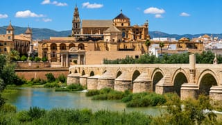 Córdoba's Roman Bridge crossing the Guadalquivir below the Mezquita-Catedral and its bell tower