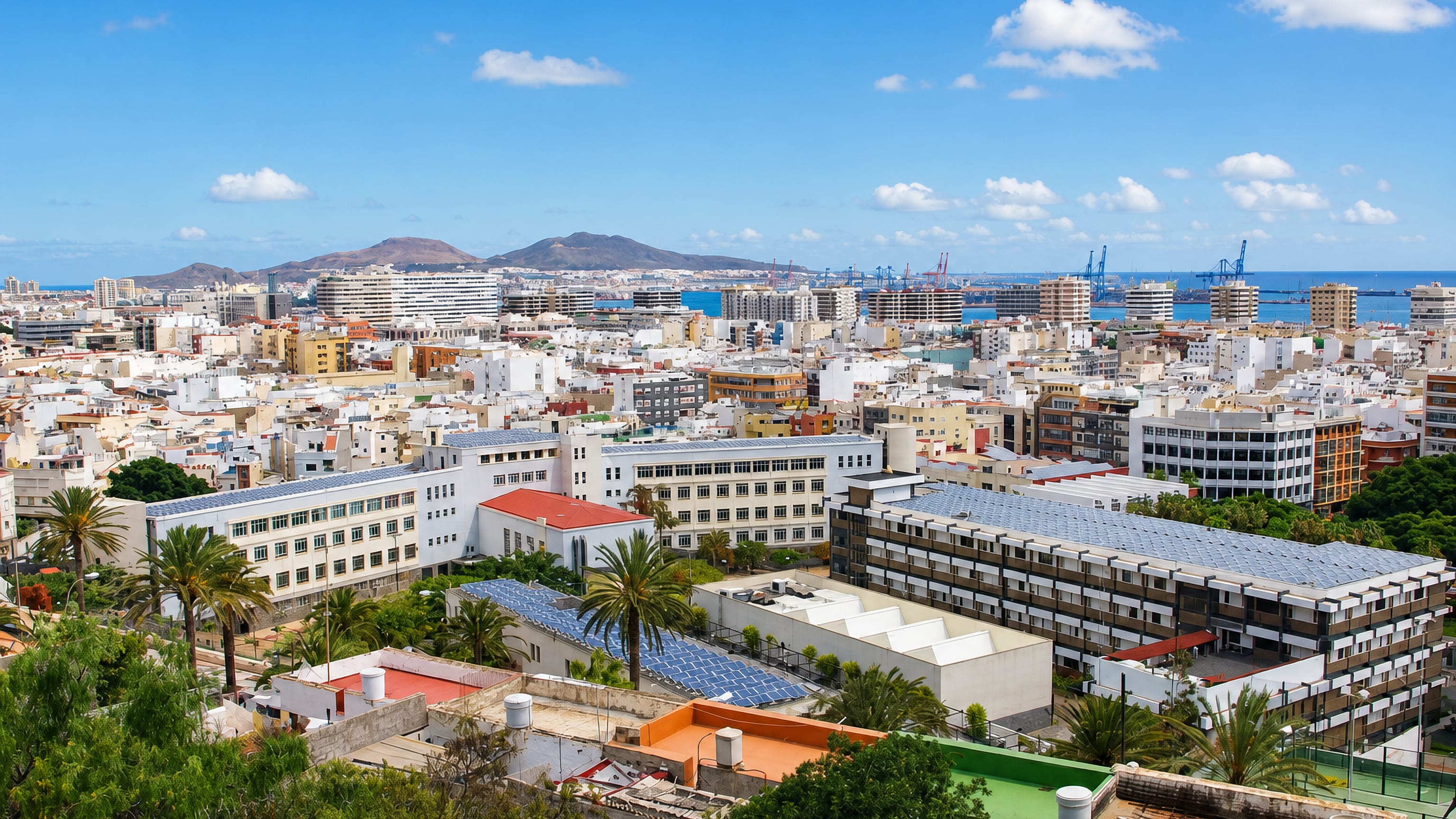 Centro in Las Palmas de Gran Canaria, white low-rise blocks running out to the port cranes and La Isleta.
