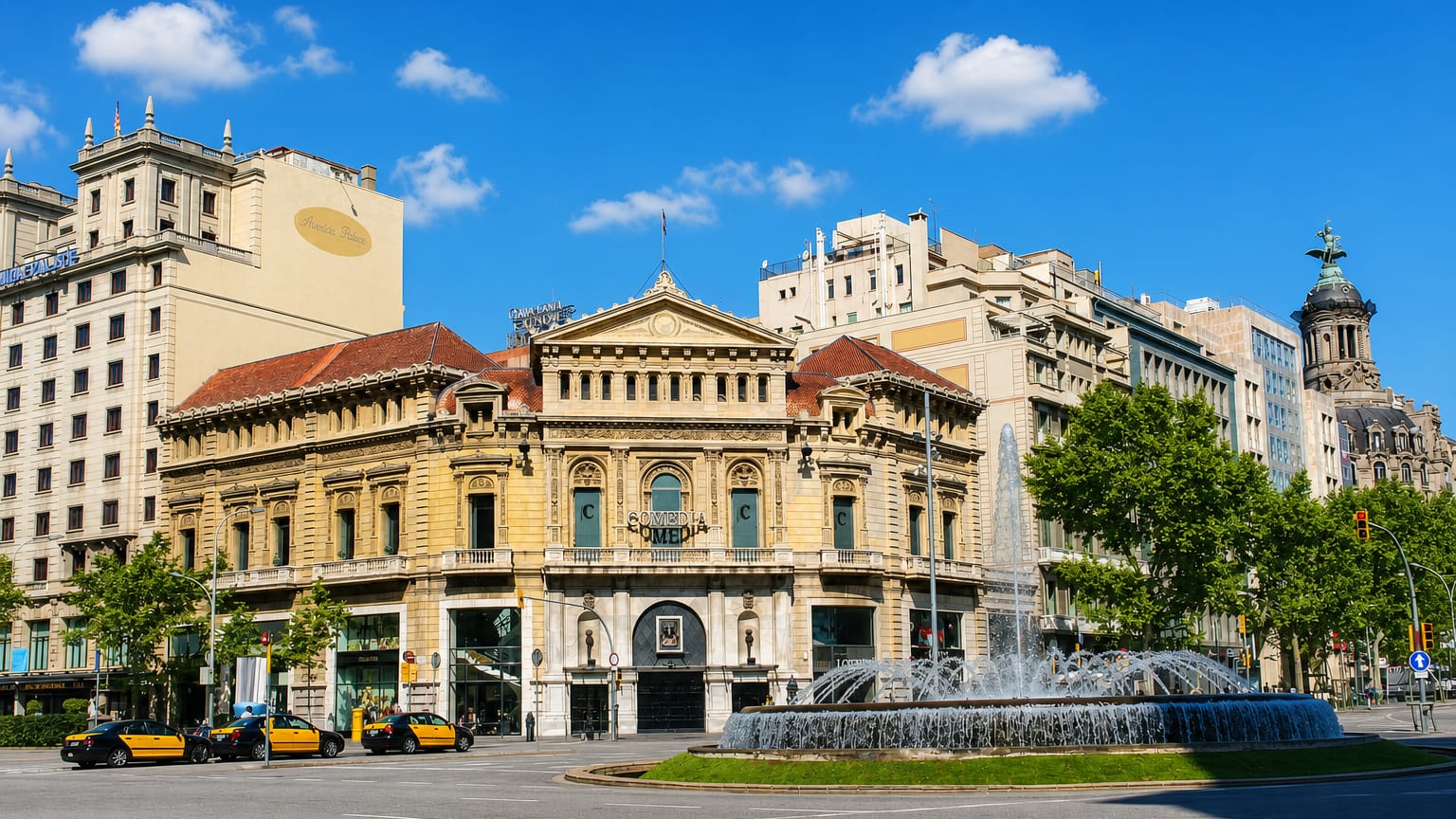 Grand Beaux-Arts theatre building and fountain on a boulevard in the Dreta de l'Eixample, Barcelona.