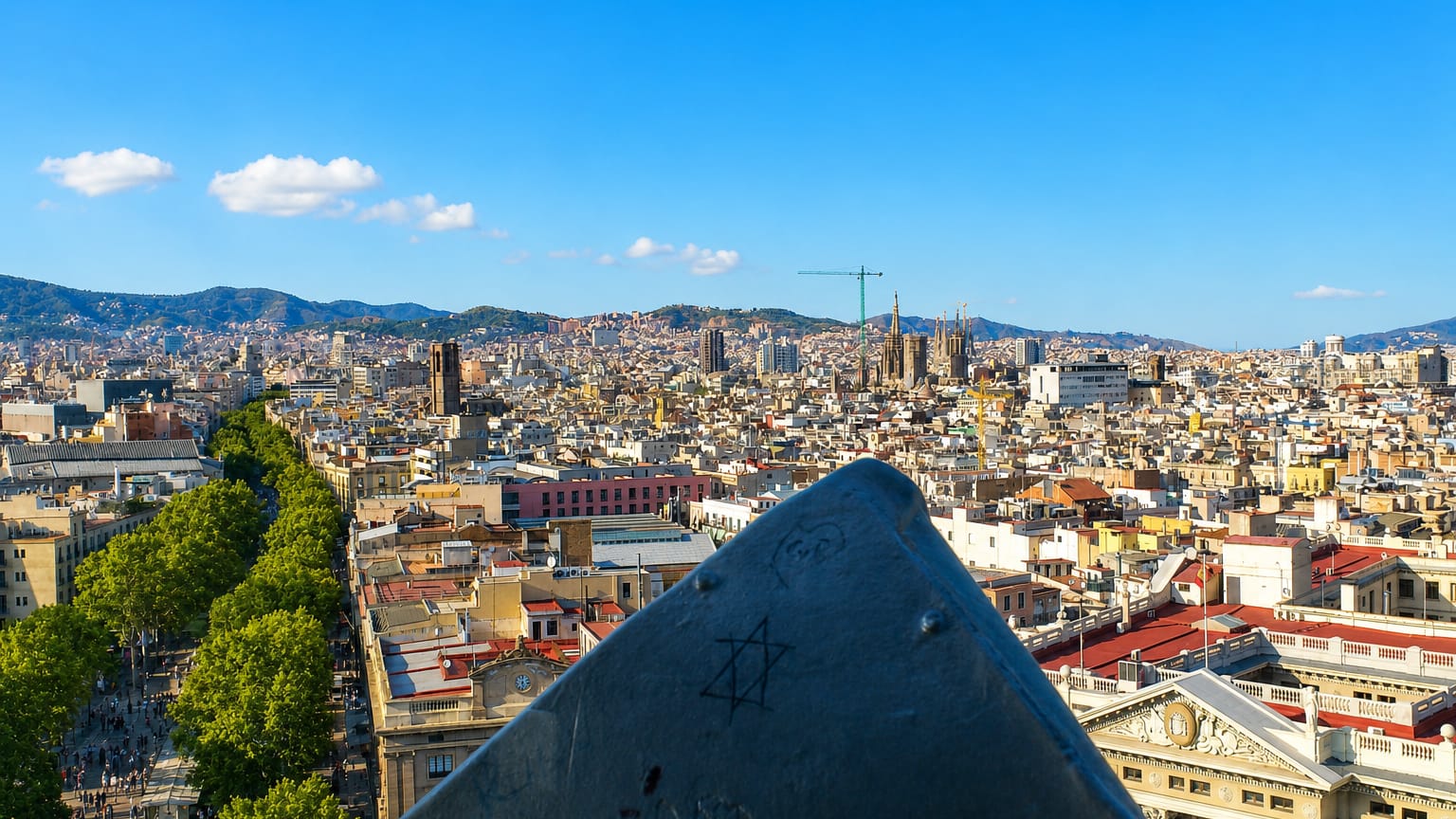 Elevated view over central Barcelona from El Raval with La Rambla and the Sagrada Familia on the skyline