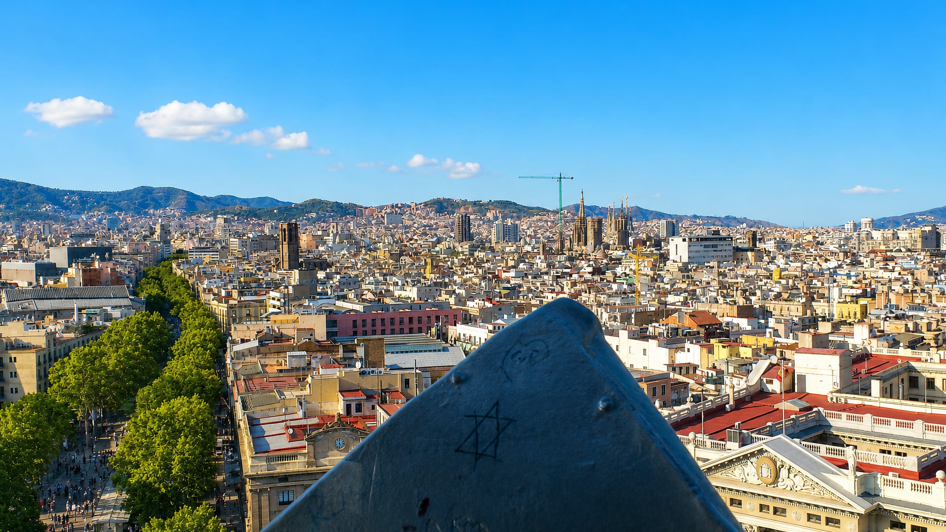 Elevated view over central Barcelona from El Raval with La Rambla and the Sagrada Familia on the skyline