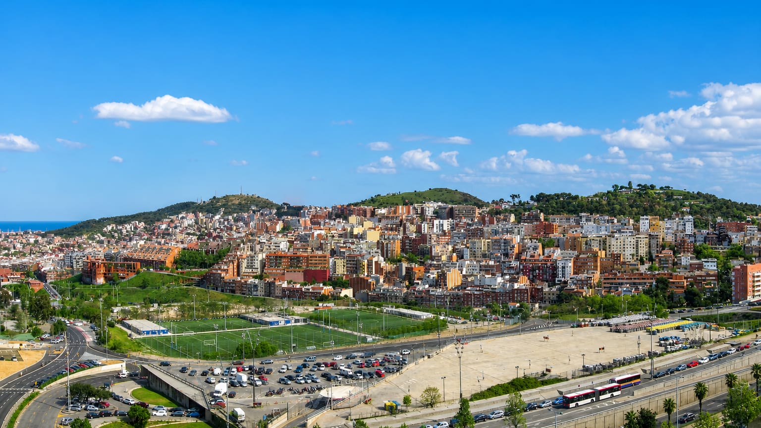 Hillside townscape of dense housing, sports fields and roads climbing the Collserola slopes in Barcelona's Horta-Guinardo district