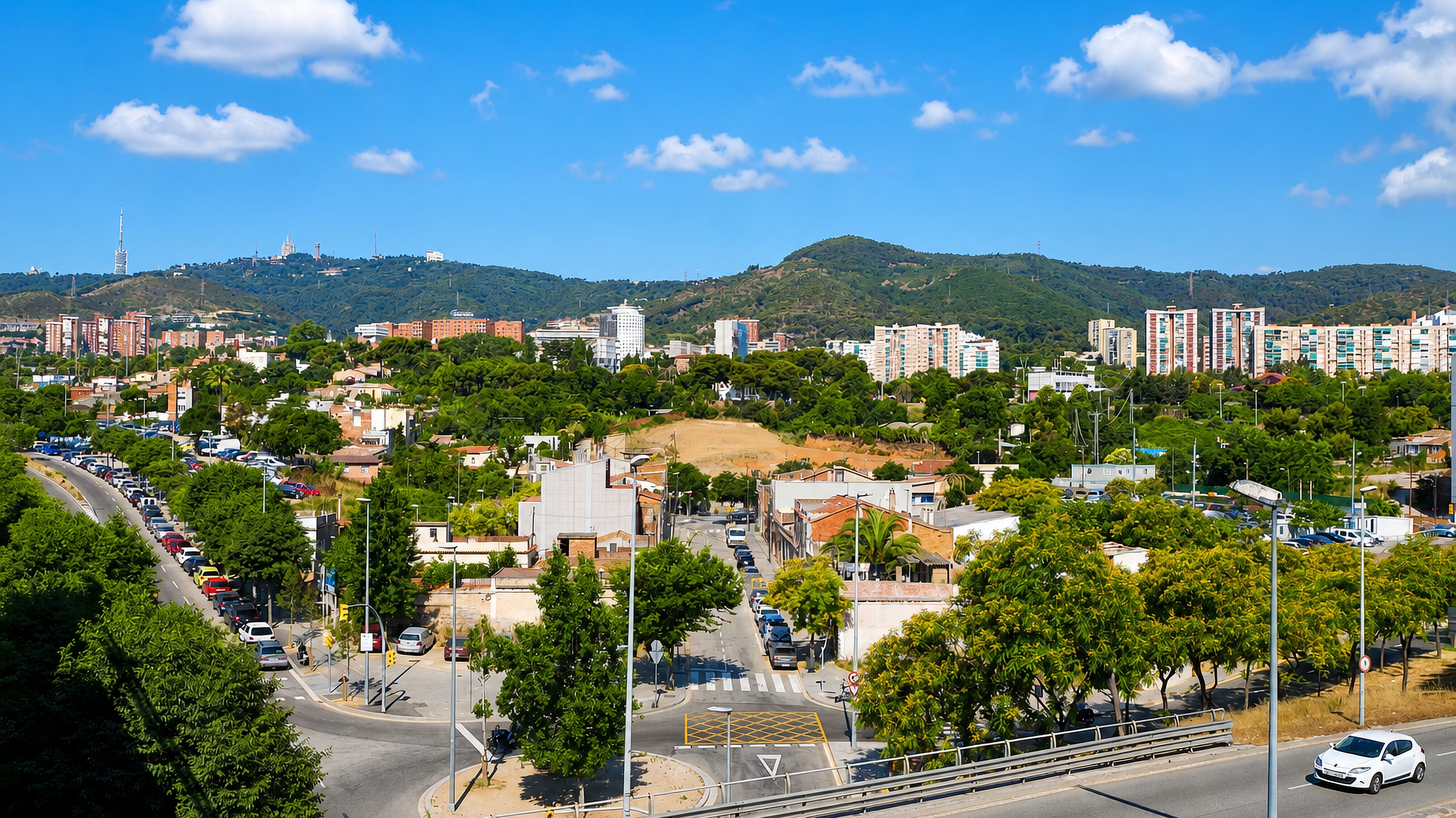 La Clota, Barcelona, low houses beside the Ronda de Dalt with Tibidabo and the Collserola tower behind.
