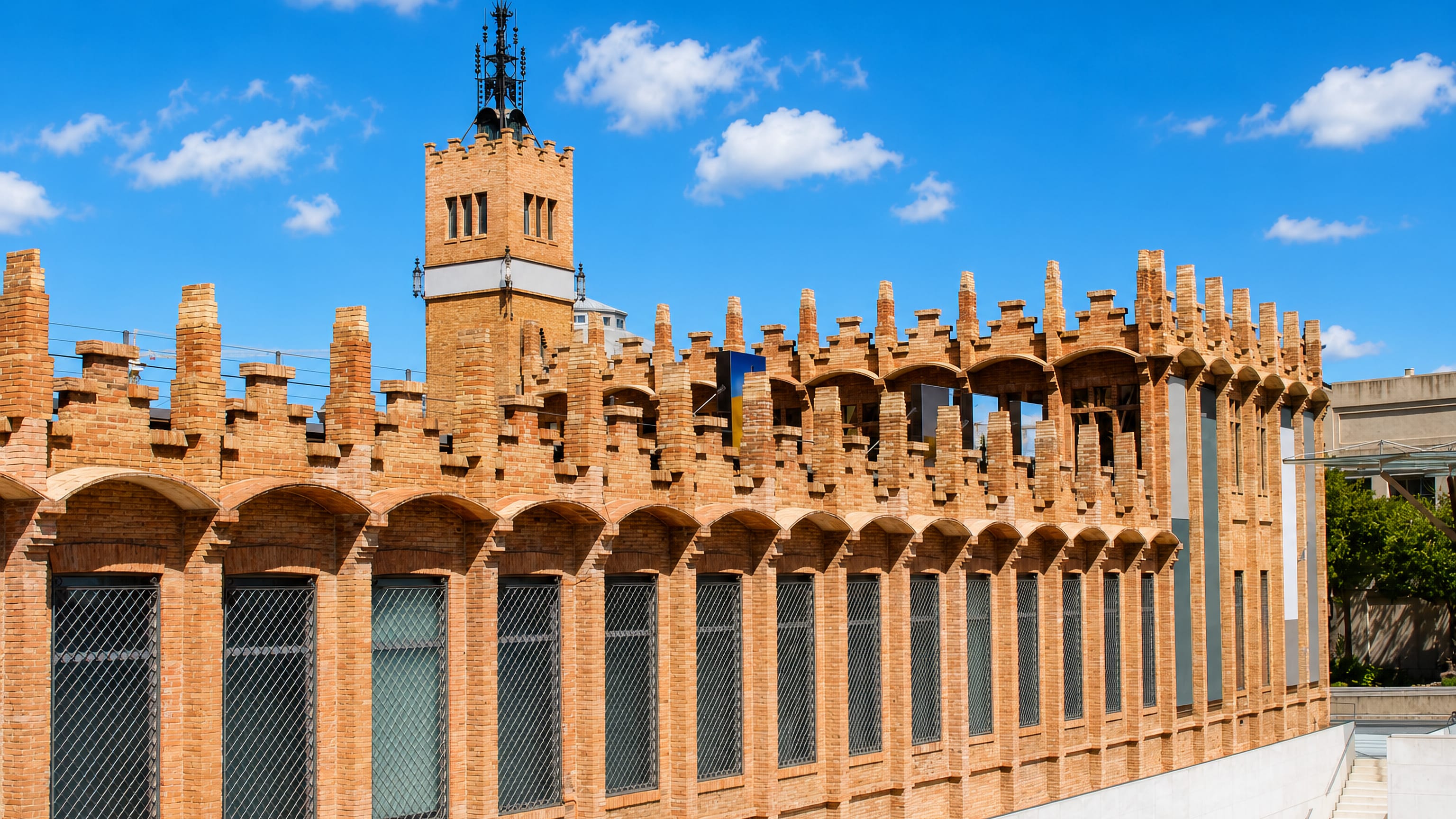 The brick modernista Casaramona building and its tower beside la Font de la Guatlla, Barcelona.