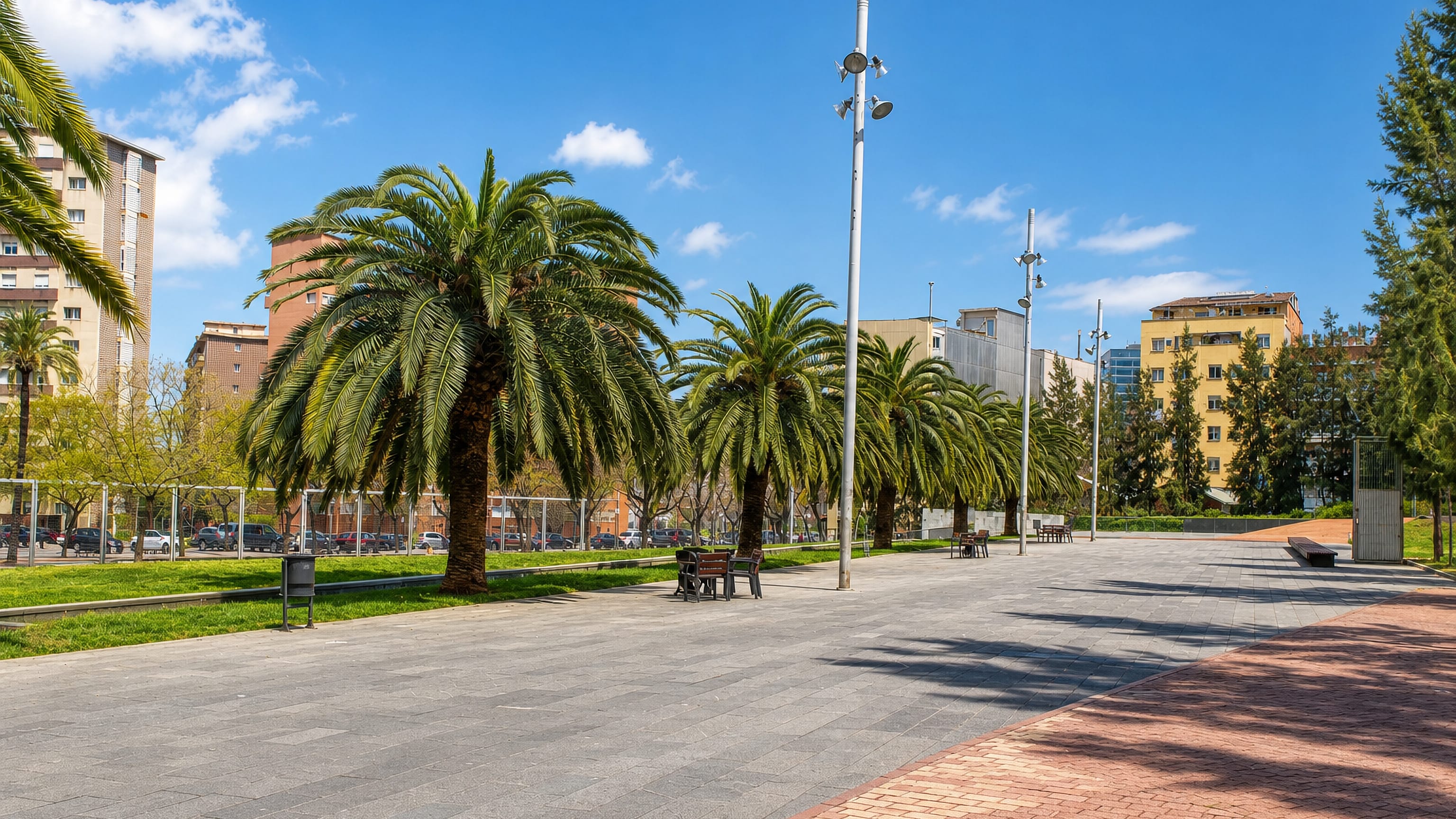 Palm-lined paved plaza between 1970s apartment blocks in la Prosperitat, Nou Barris, Barcelona