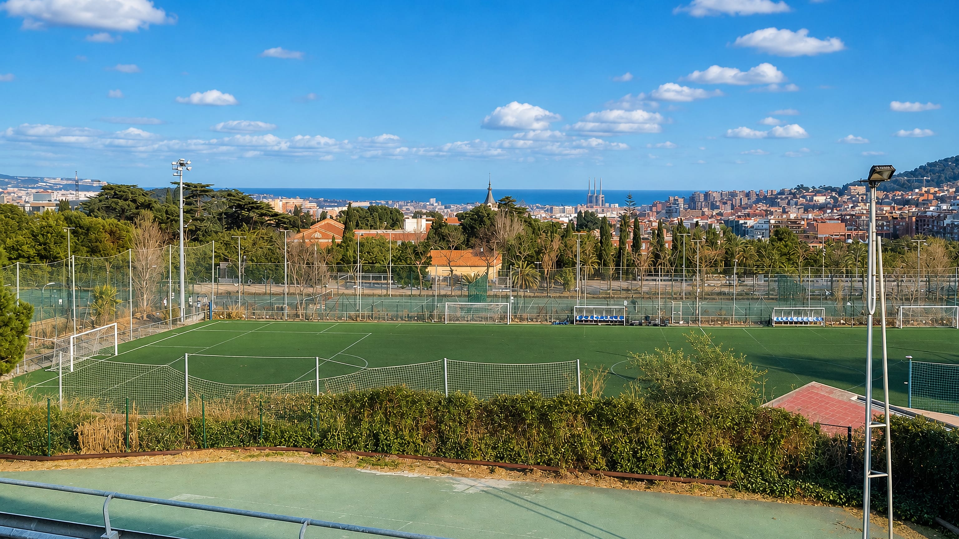 Sports pitches at la Vall d'Hebron above Barcelona, with the Sagrada Família and the sea beyond.
