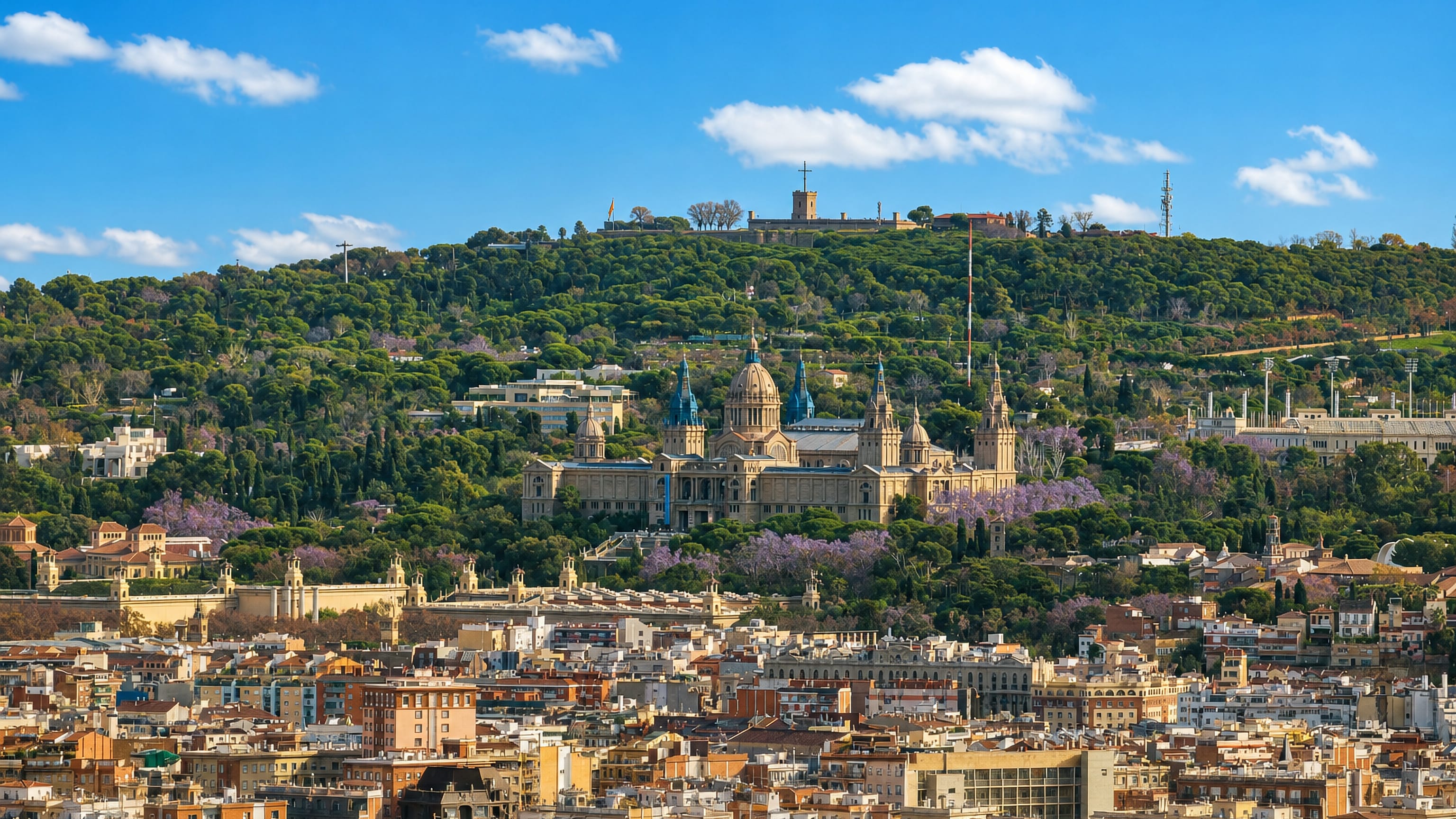 The Palau Nacional and hilltop castle on Montjuïc rising above Barcelona's rooftops in spring.