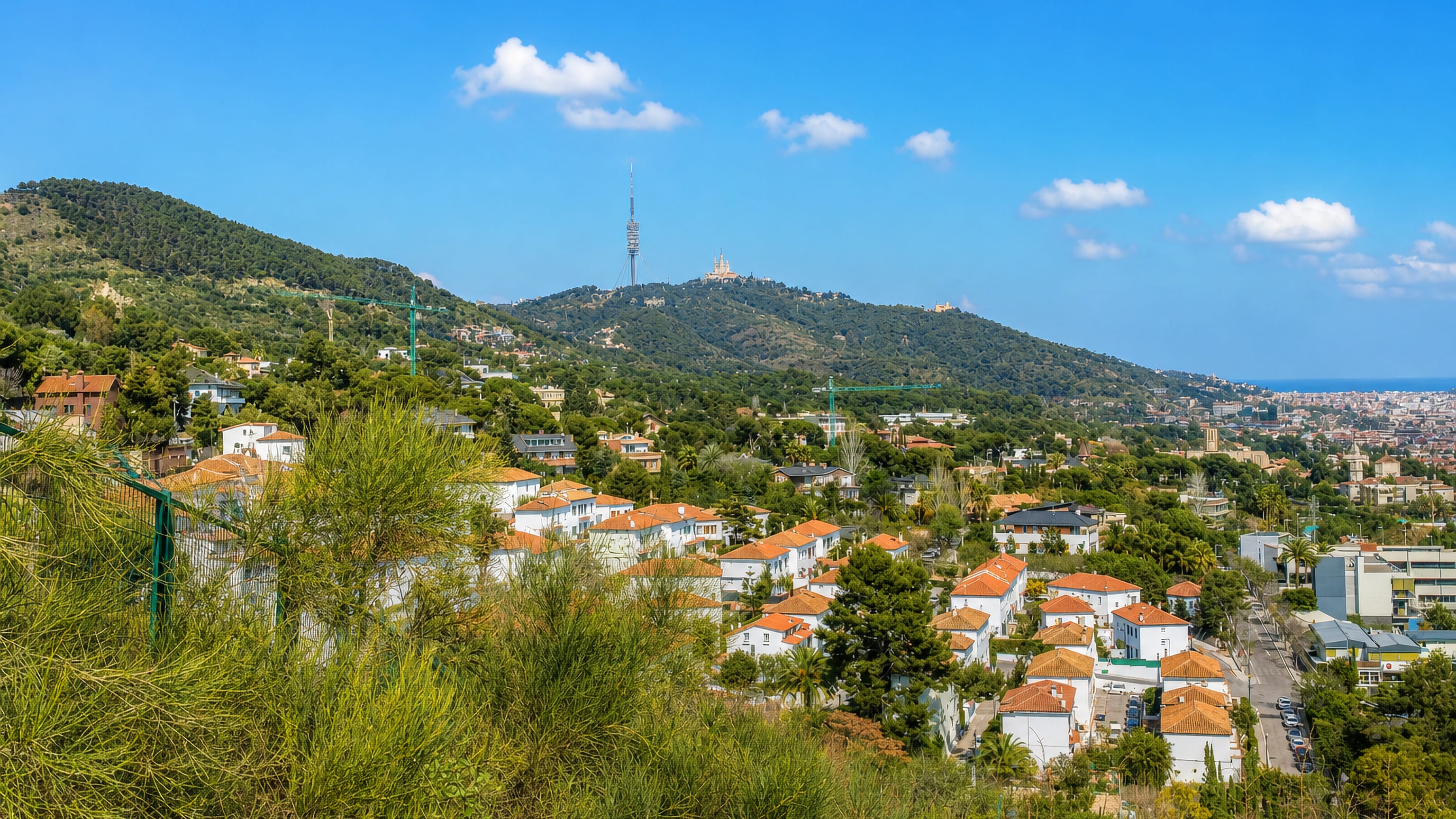 Villas of Pedralbes, Barcelona, below the wooded Collserola ridge with its tower and the Tibidabo church.