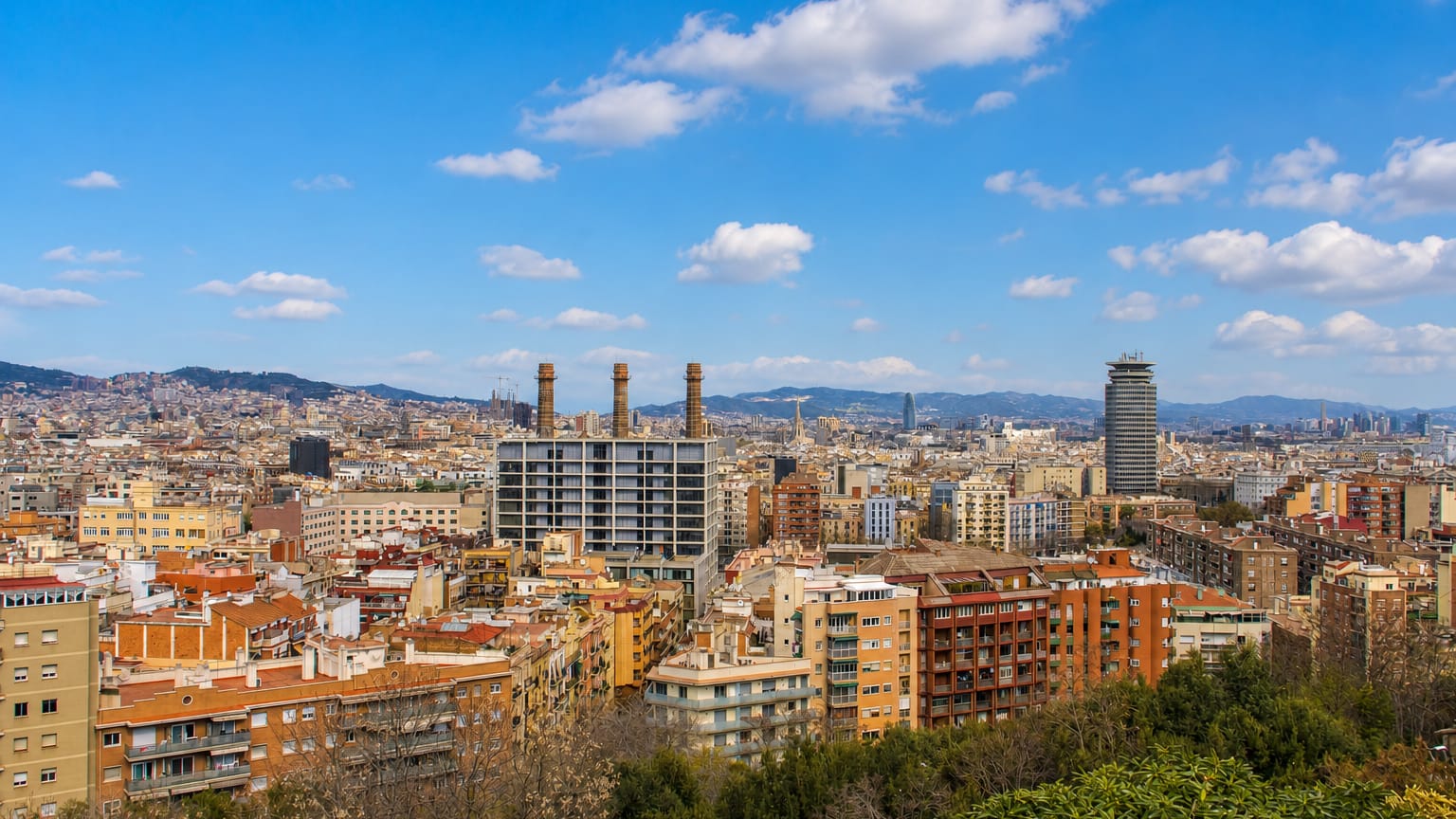 Rooftops of Poble Sec below Montjuic with the three chimneys of the old Paral·lel power station, Barcelona.