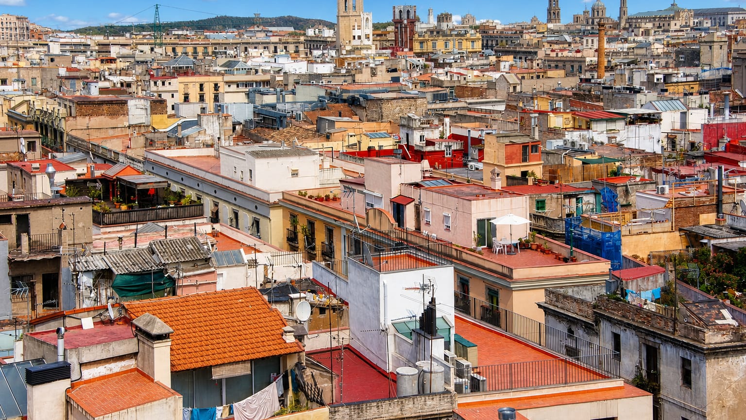 Rooftop view over the dense terracotta roofs and church towers of Sant Pere, Santa Caterina i la Ribera in Barcelona's old town.