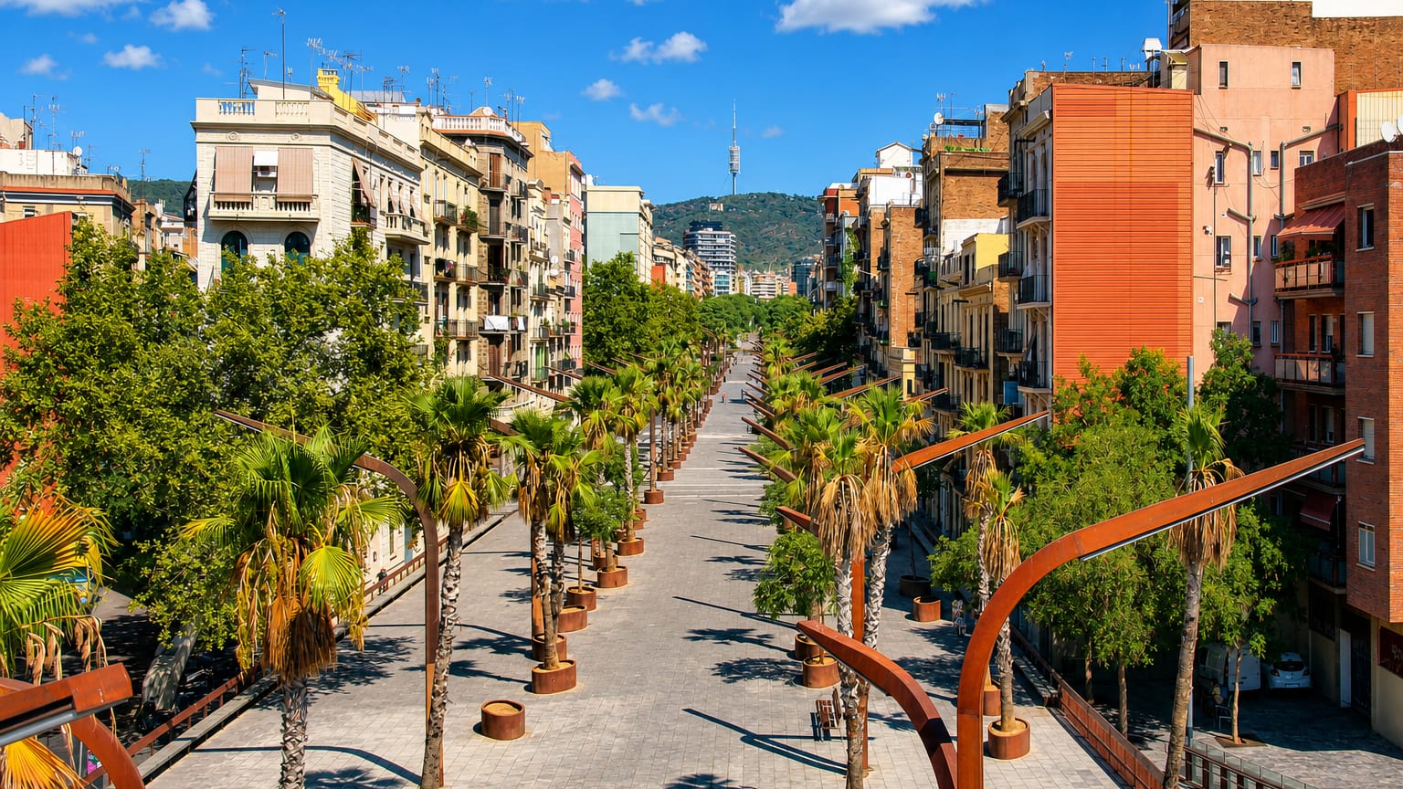 Palm-lined pedestrian rambla in the Sants-Badal district of Barcelona, with the Torre de Collserola rising on the wooded ridge beyond.