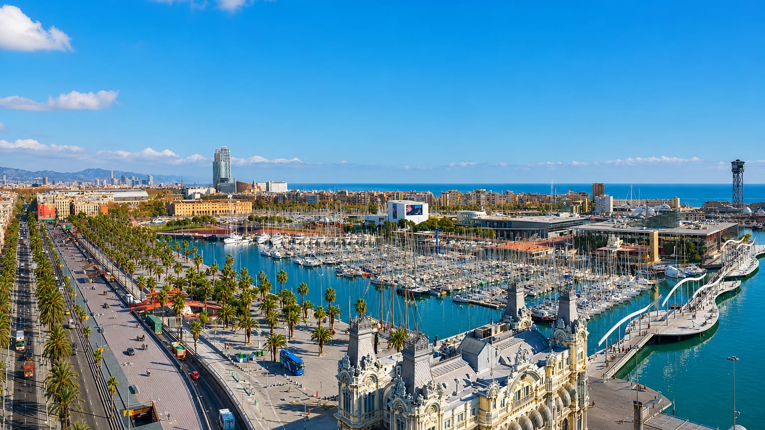 Barcelona's Port Vell waterfront with the ornate Port Authority building, marina, Rambla de Mar bridge and cable-car tower