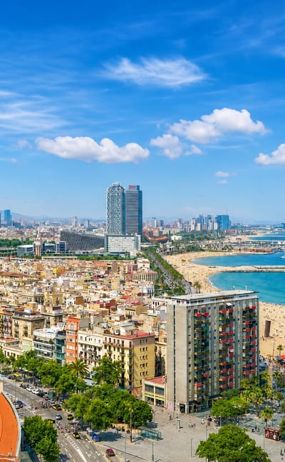 Barcelona seafront with Port Olimpic towers and a busy beach, standing in for the Sants district