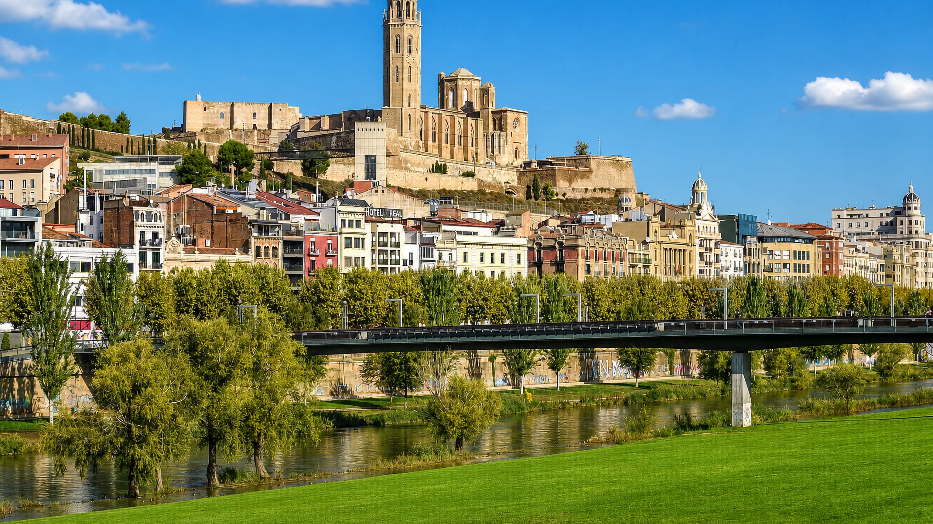 La Seu Vella cathedral and castle crowning the hill above the Segre river and footbridge in Lleida, Spain.
