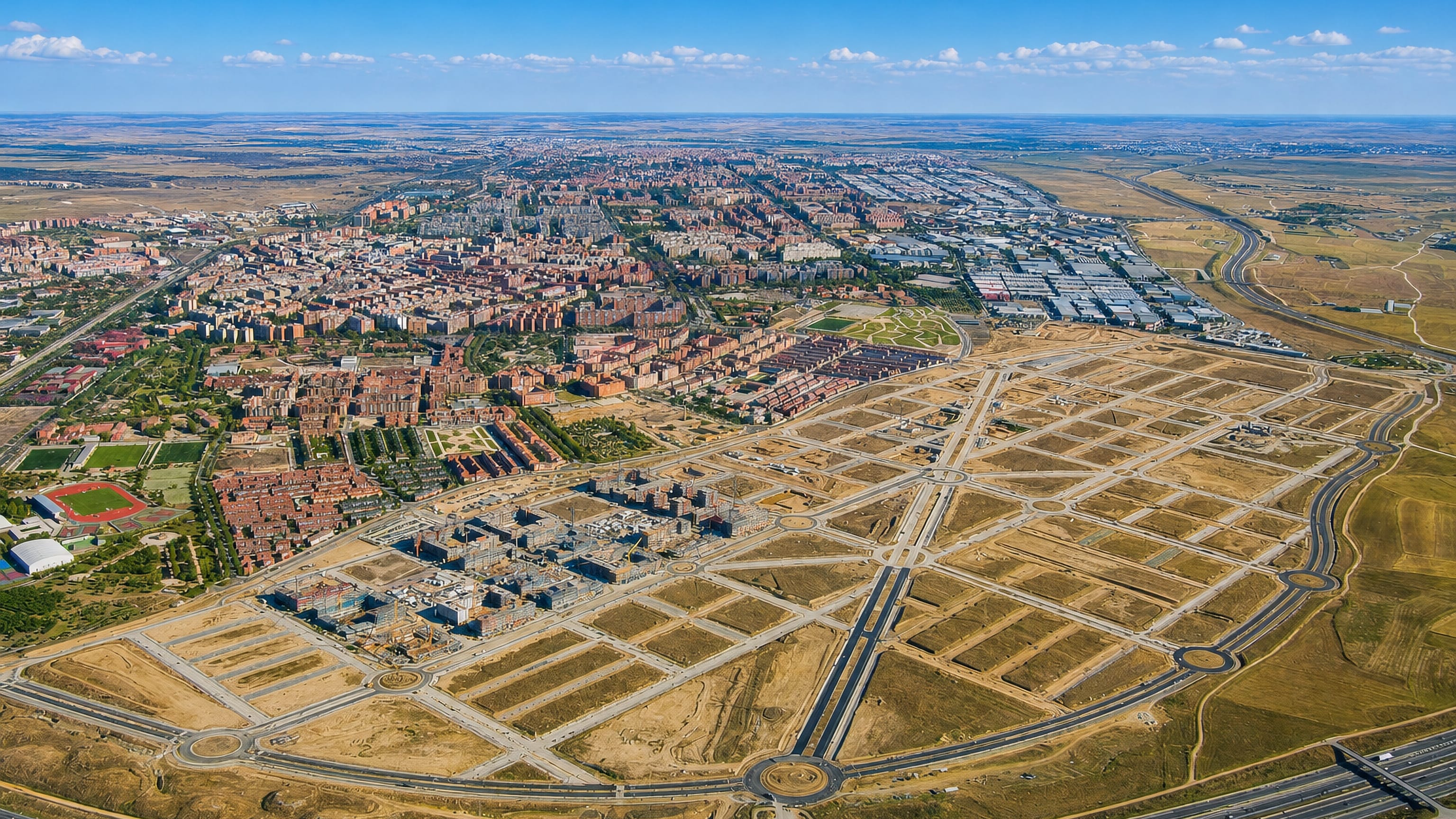 Aerial view of Alcorcon outside Madrid, brick apartment blocks meeting the empty street grid of a new district