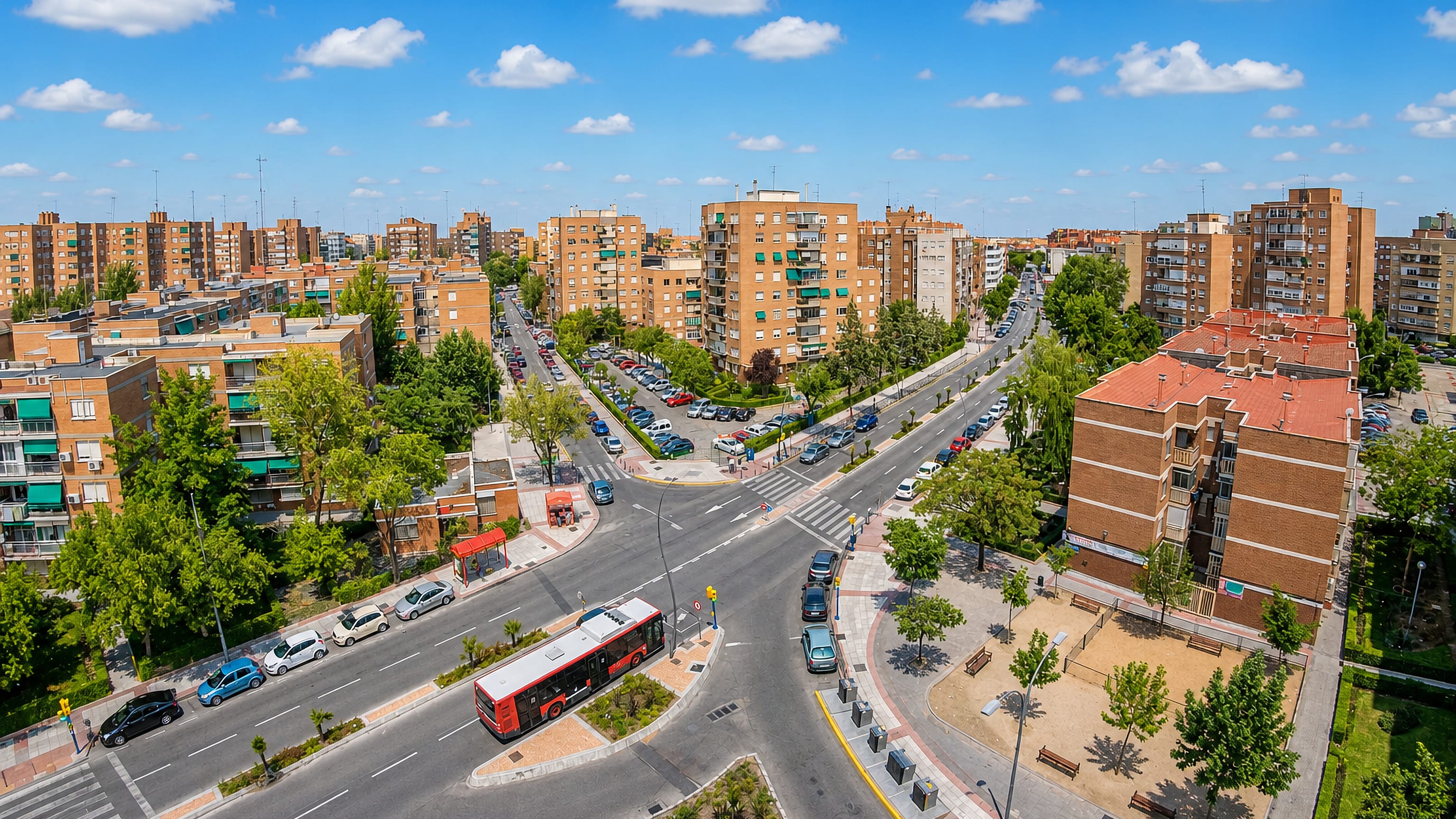 Aerial view of Fuenlabrada near Madrid, showing brick apartment blocks, a tree-lined avenue and a city bus.