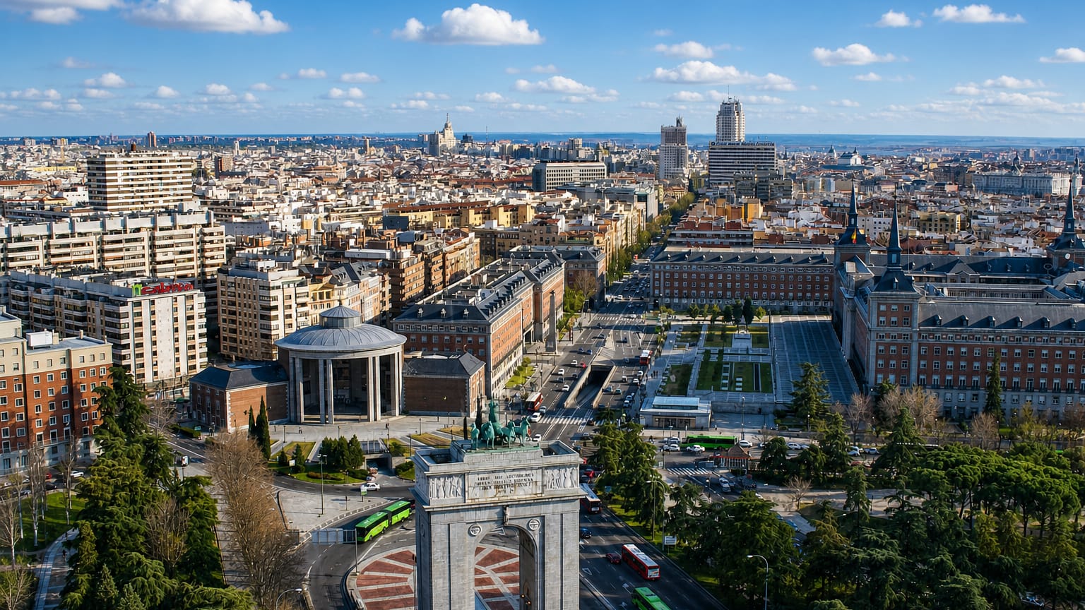 Aerial view of Madrid's Arco de la Victoria and Moncloa district with the city skyline stretching behind, near Aravaca