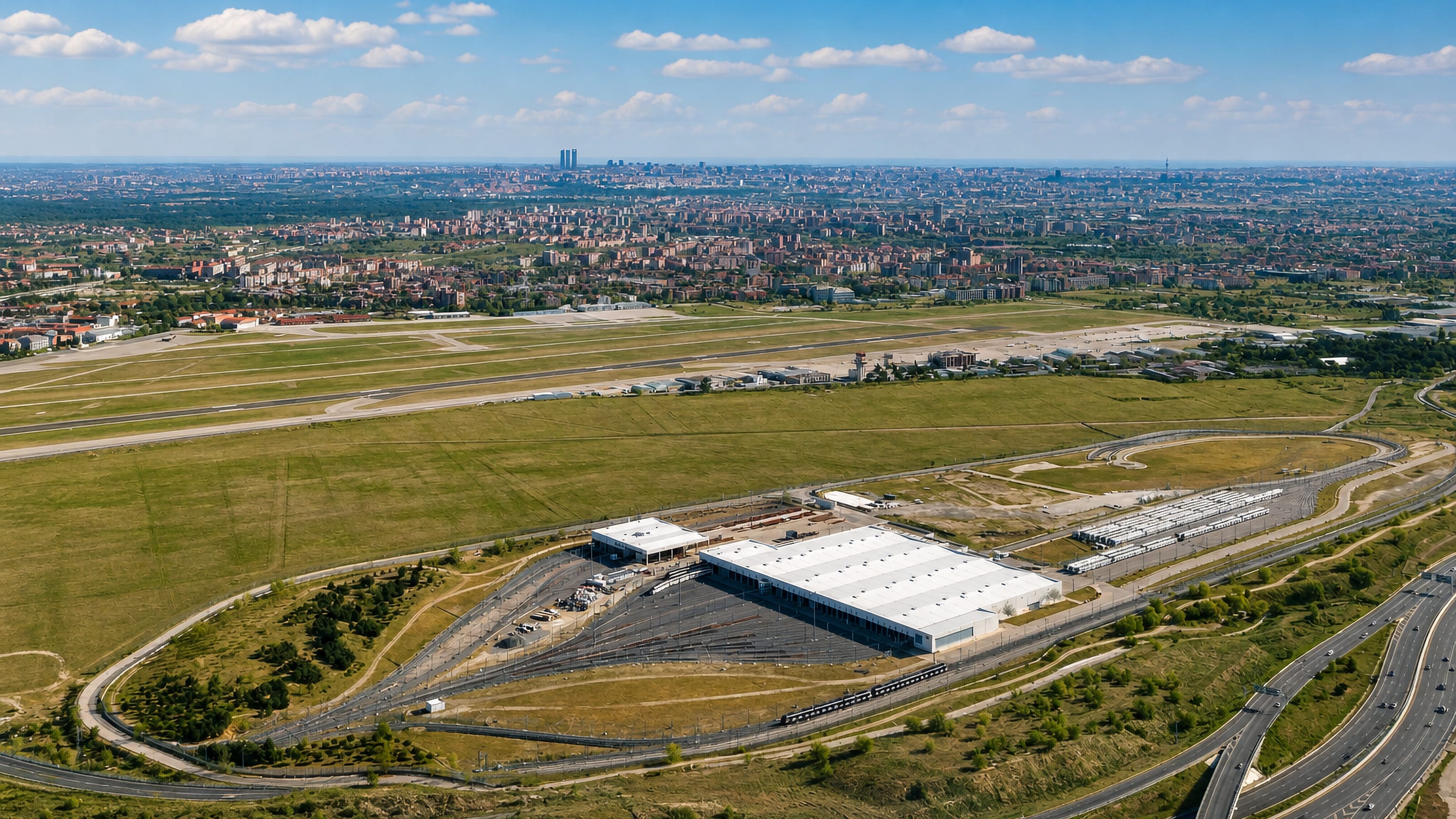 Cuatro Vientos airfield and depot on Madrid's southwestern edge, with the city skyline on the horizon.
