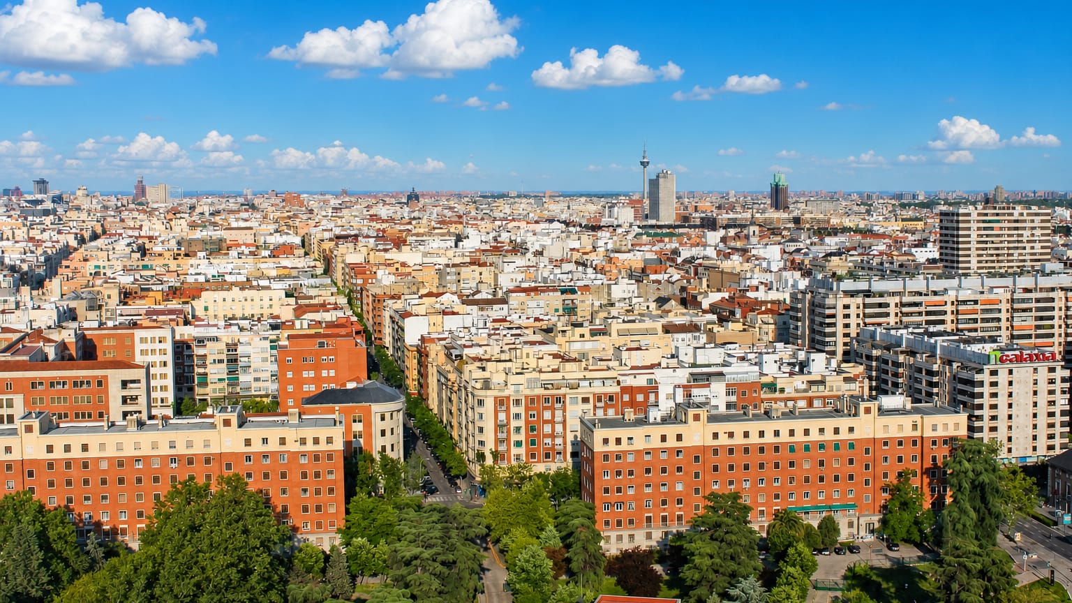 Aerial view of dense mid-rise residential blocks and tree-lined streets across the Gaztambide neighborhood of central Madrid.