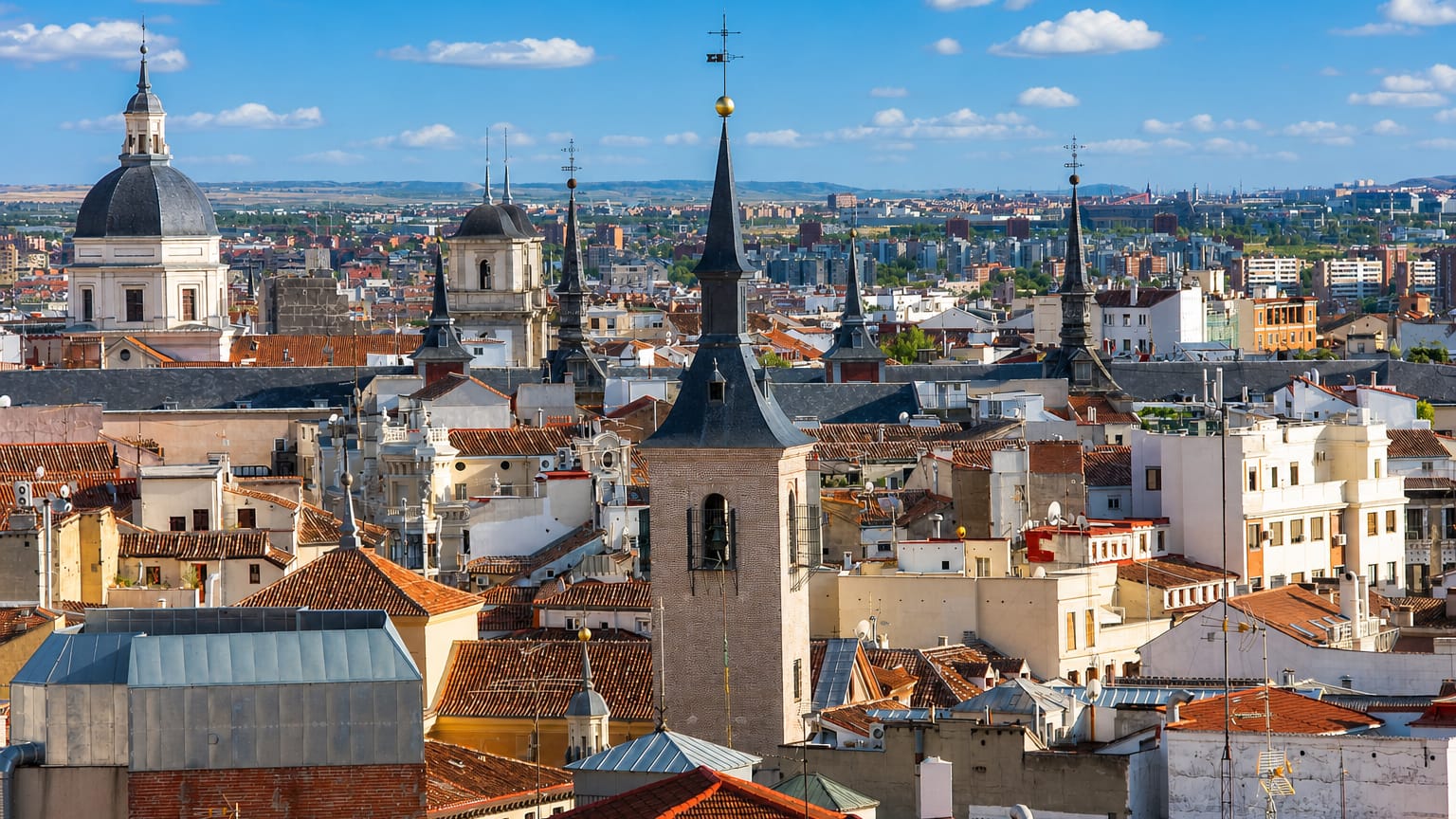 Rooftop skyline of central Madrid showing domes, spires and church towers across Madrid Centro.