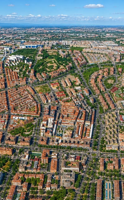 Aerial view over the dense residential grid of Madrid's Portazgo neighbourhood on a clear day