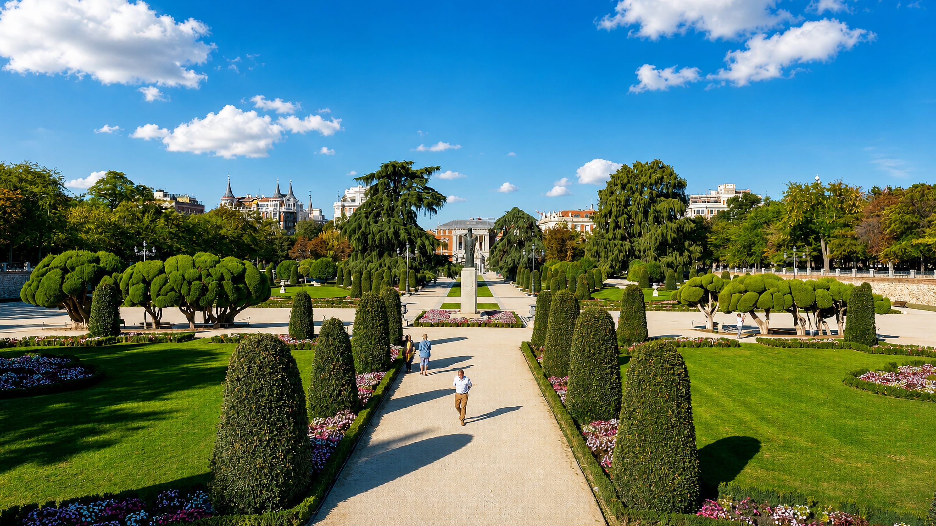 Formal gardens, clipped hedges and tree-lined paths of El Retiro Park in the Retiro district of Madrid.