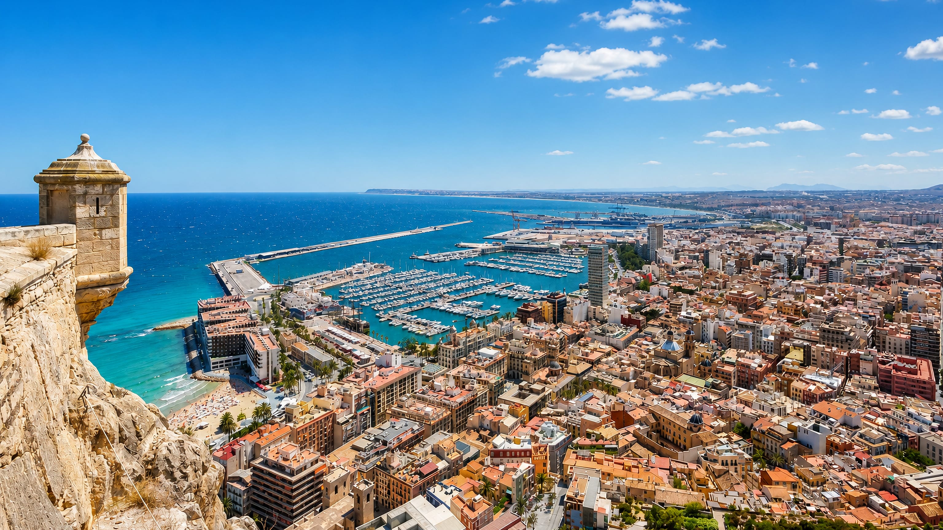Alicante's old town, Postiguet beach and marina seen from a bartizan of Santa Bárbara Castle on Mount Benacantil