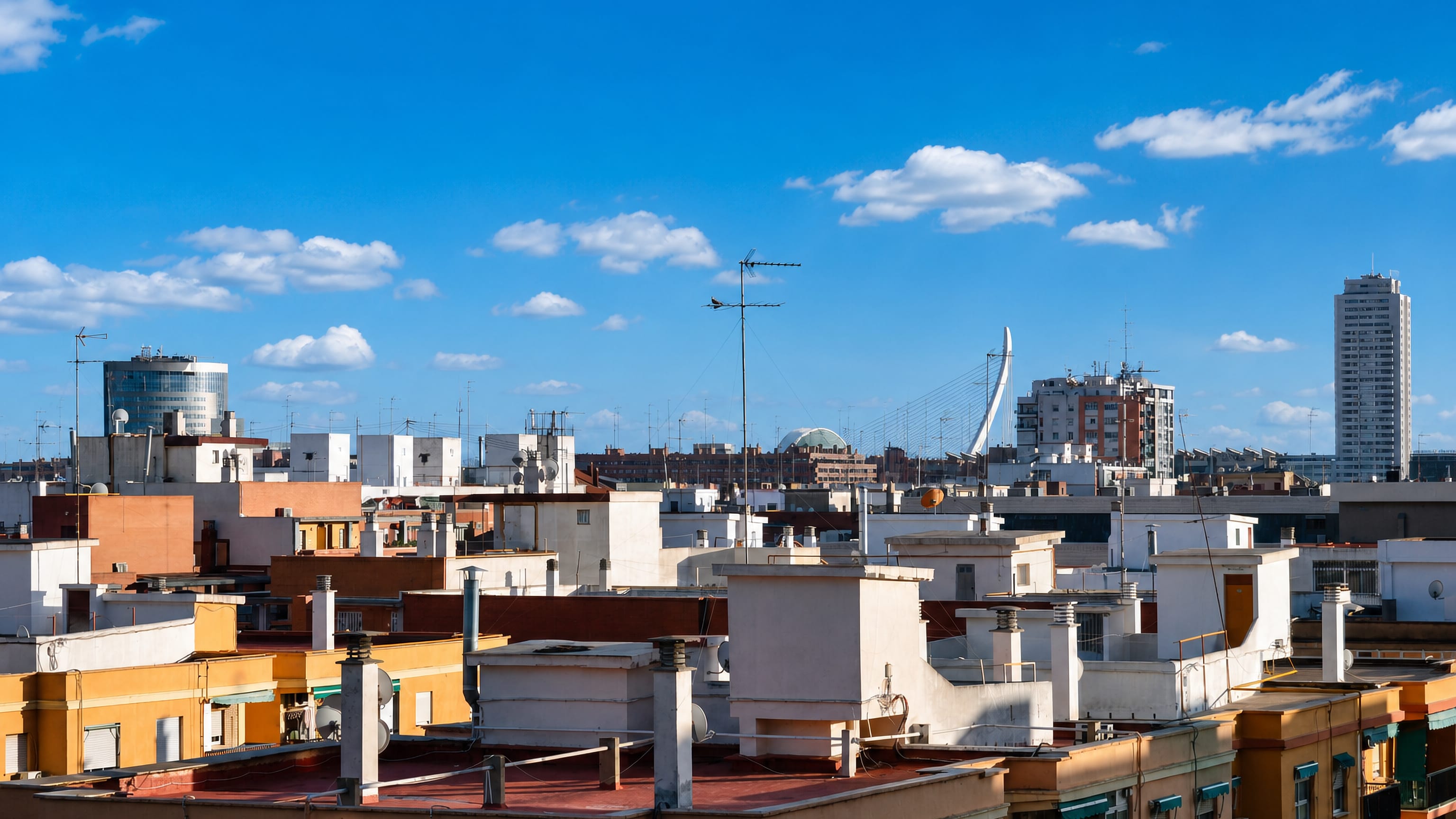 Rooftops of Albors in Valencia with a Calatrava bridge pylon and a tower block on the skyline.