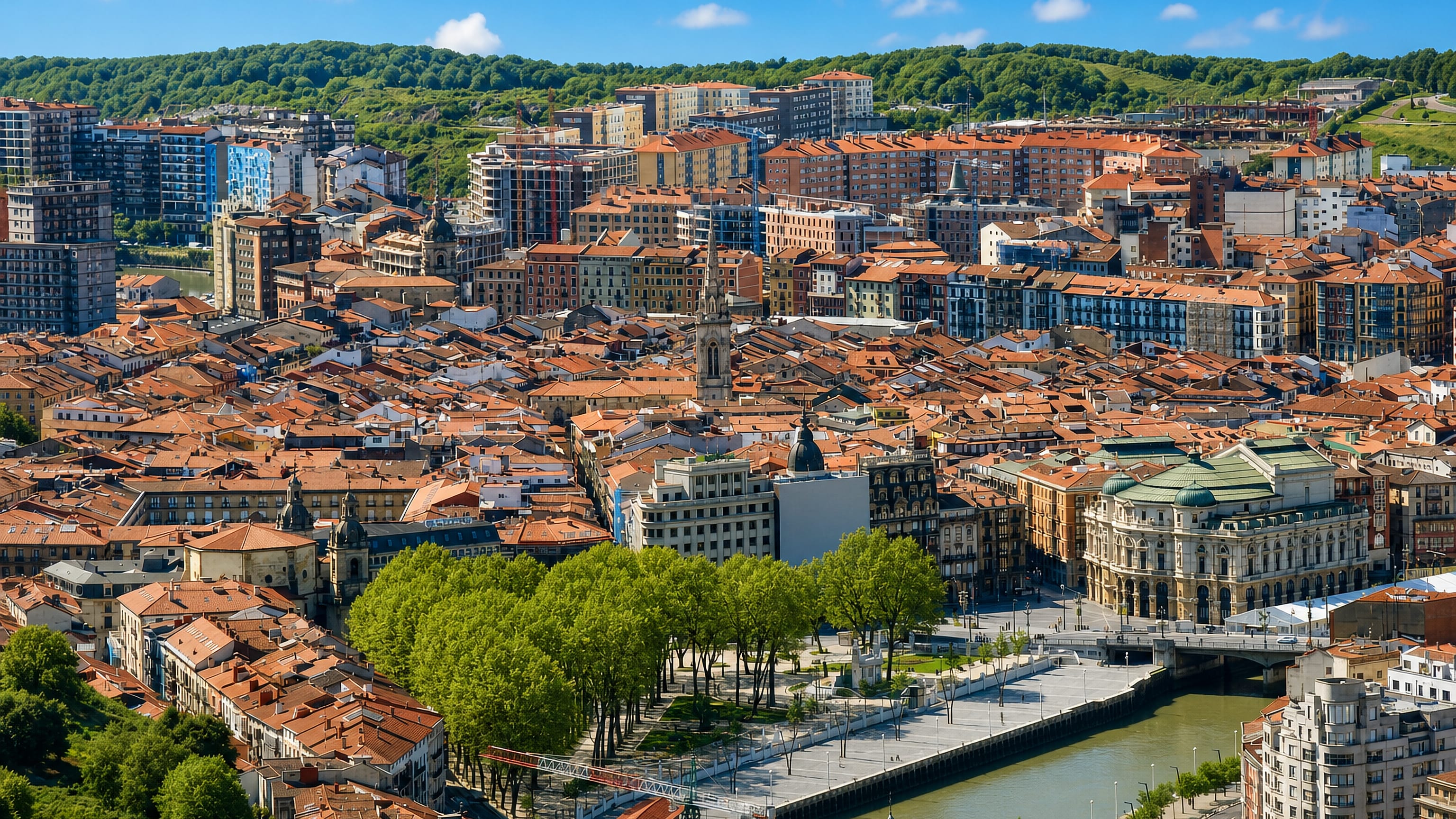 Terracotta rooftops of Bilbao's Zazpi Kaleak old town beside the Nervión river and Arriaga Theatre.