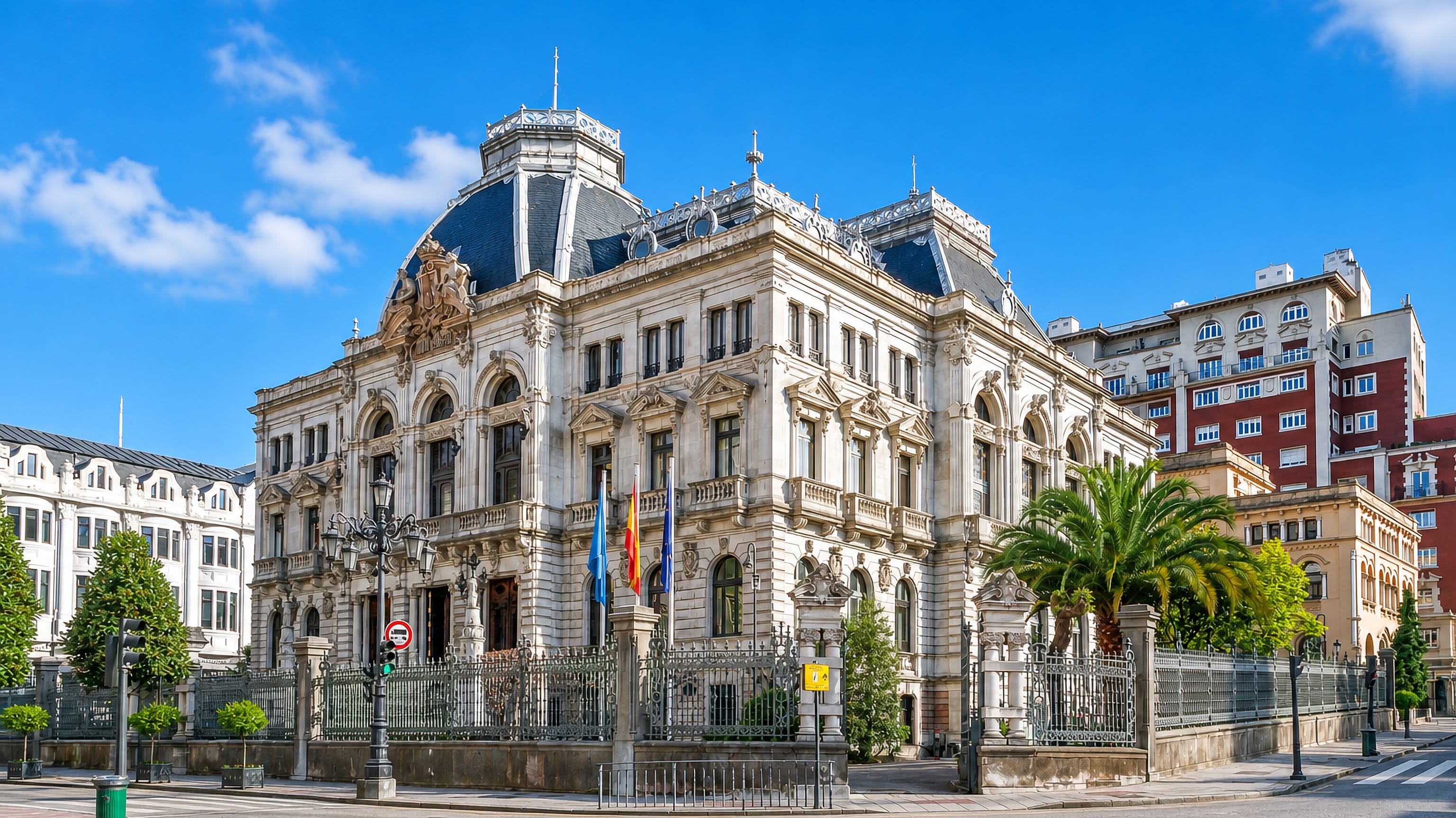 The white stone Junta General del Principado de Asturias palace in Oviedo under a clear blue sky