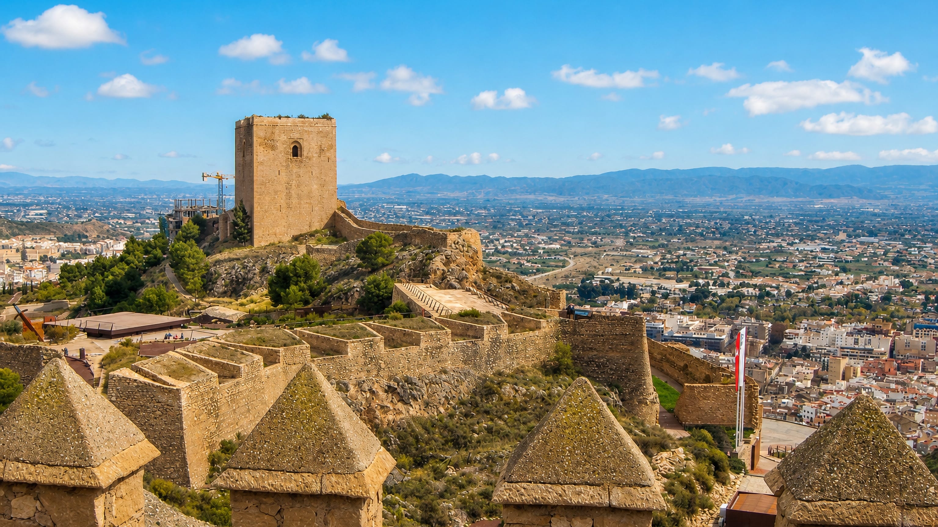 Lorca Castle's Alfonsina tower and walls above the town of Lorca and its Murcian plain in southeast Spain.