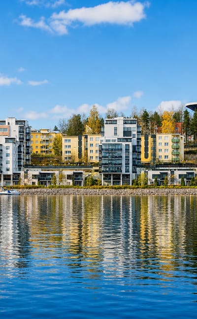 Modern lakeside apartment blocks and a saucer-shaped water tower on the autumn lakeshore of Kuokkala, Jyväskylä, Finland