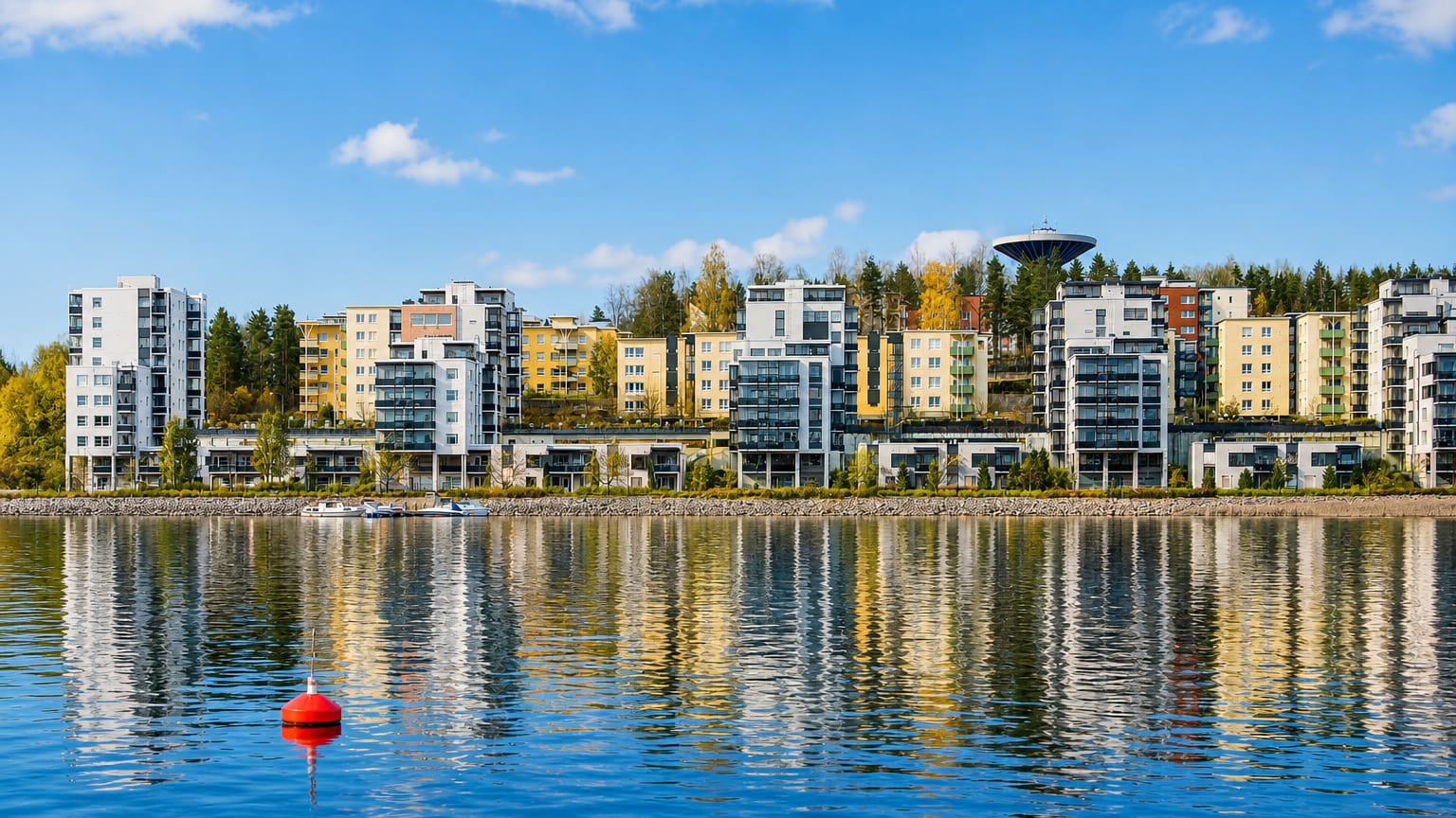 Modern lakeside apartment blocks and a saucer-shaped water tower on the autumn lakeshore of Kuokkala, Jyväskylä, Finland