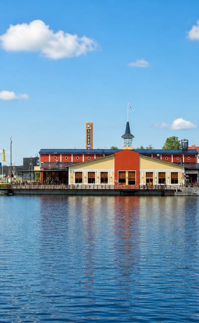 A red waterfront market building reflected in the lake at Viitasaari, central Finland.