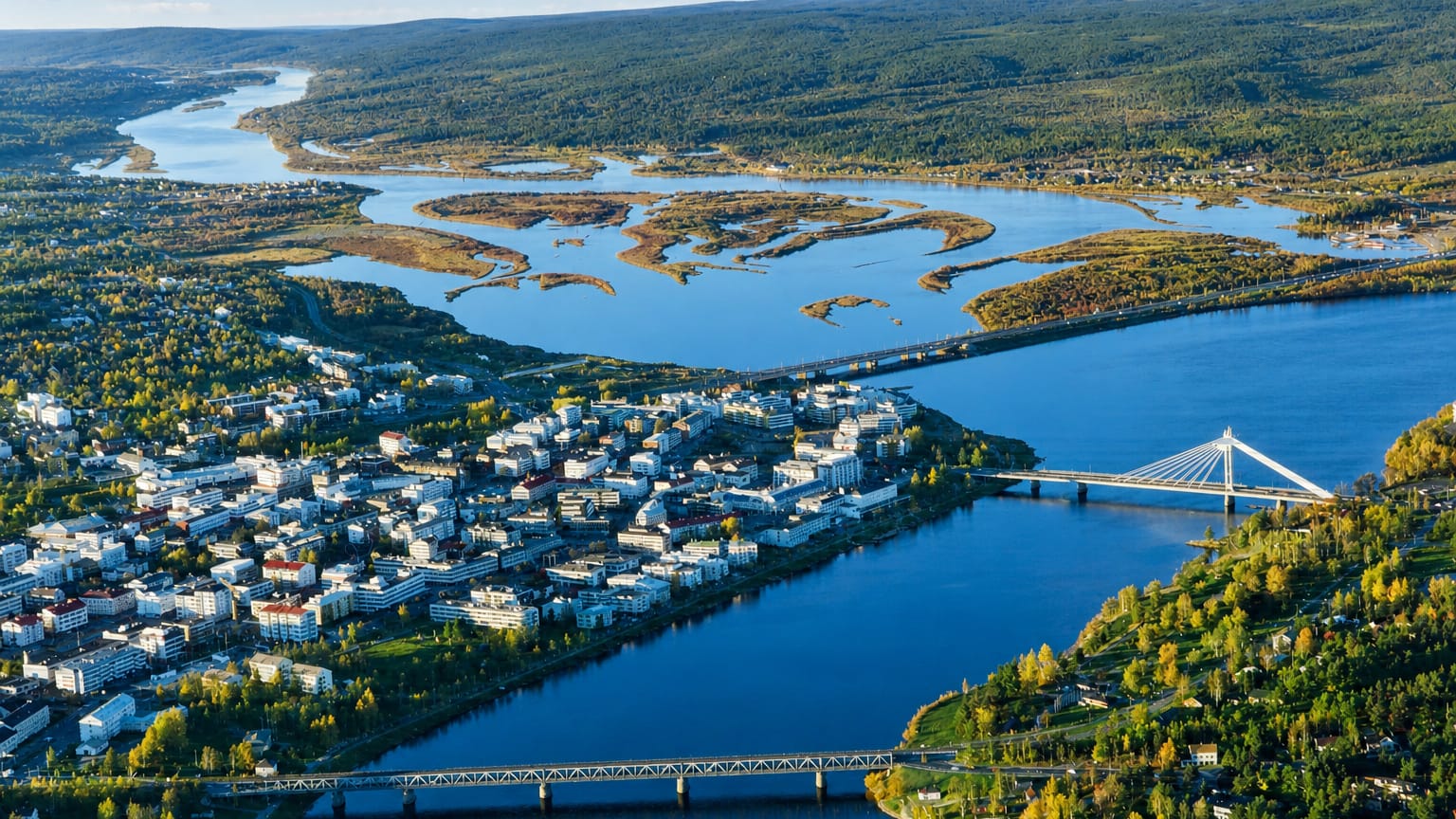 Aerial view of Rovaniemi, Finland, at its river confluence with the cable-stayed Jätkänkynttilä Bridge